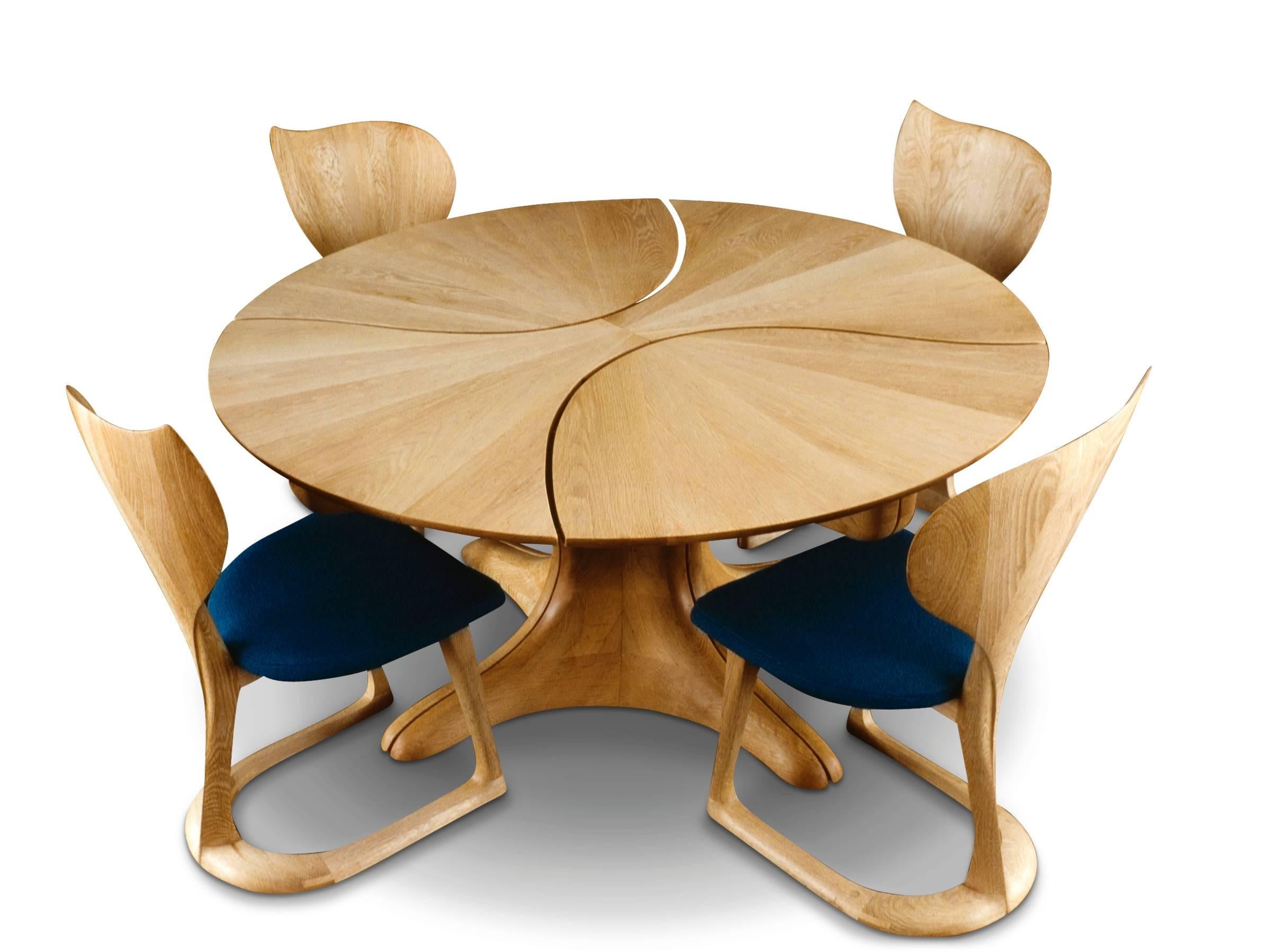 Made from bleached white oak, this table is a variation on an earlier version of the Lily Pad table. This circular table extends to an oval, extension leaves store under the table top when not in use.

Table seen here with 
