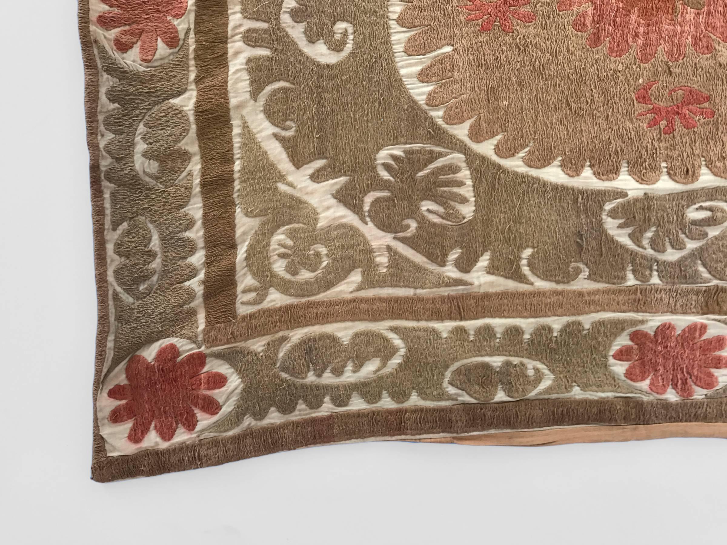 Oversized vintage embroidered Suzani pillow with traditional paisley patterning in shades of brown, tan and pink over a cream background.

Measures: 48 x 40 in.

Perfect for use as a floor, dog or pet pillow.

Pillow is not sold with insert.