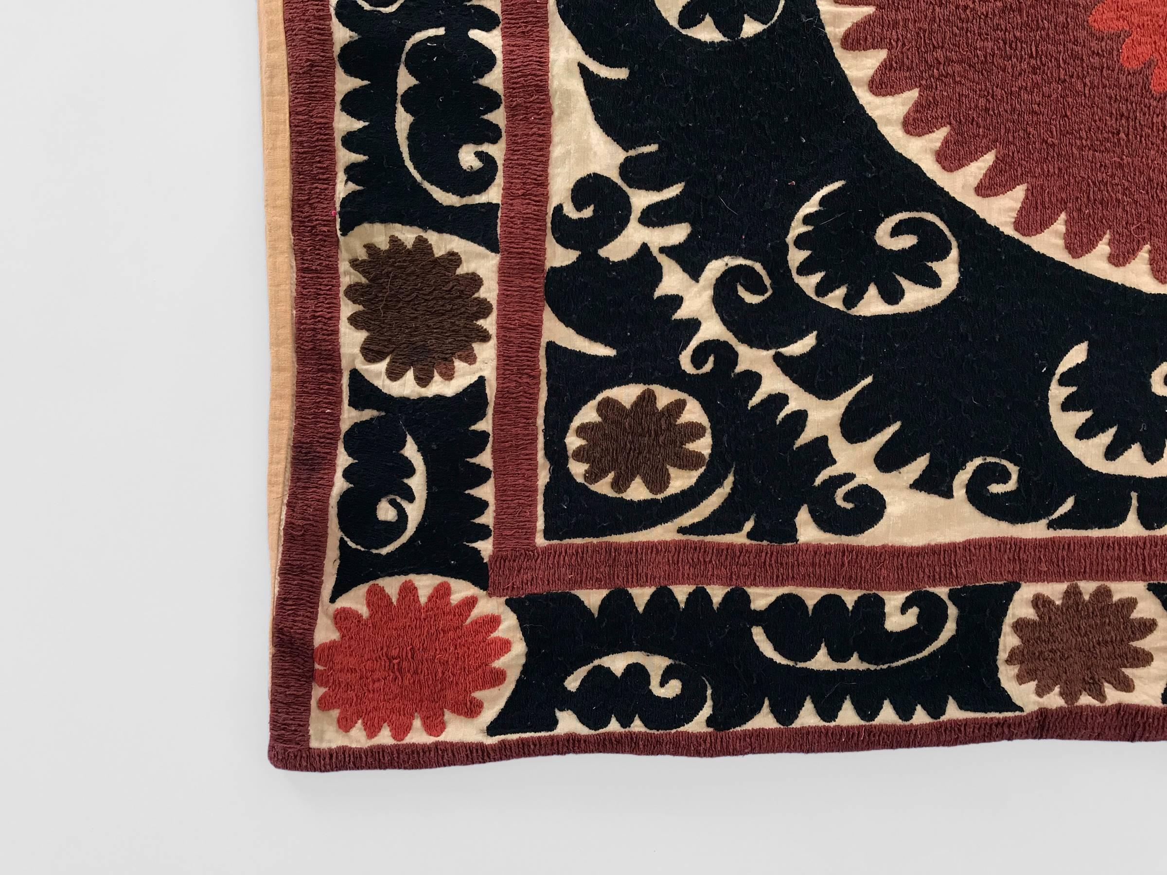 Oversized vintage embroidered Suzani pillow with traditional patterning in shades of black, red and maroon over a cream background.

Measures: 51 x 43 in.

Perfect for use as a floor, dog or pet pillow.

Pillow is not sold with insert. Custom