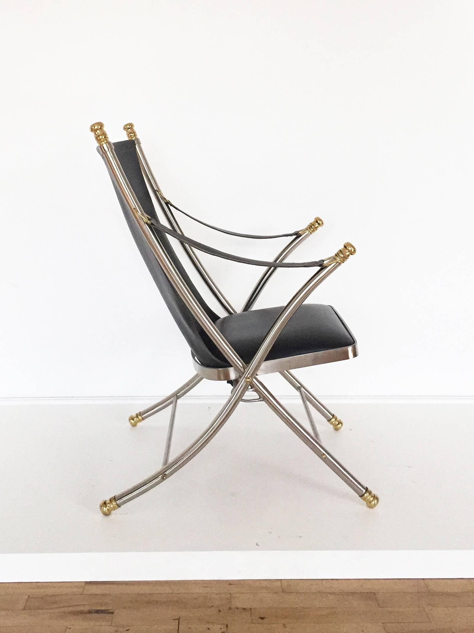 Incredible folding campaign chair from the 1970s made from tubular and flat steel, brass and leather. Seat folds via hand release under seat. Each foot impressed with 