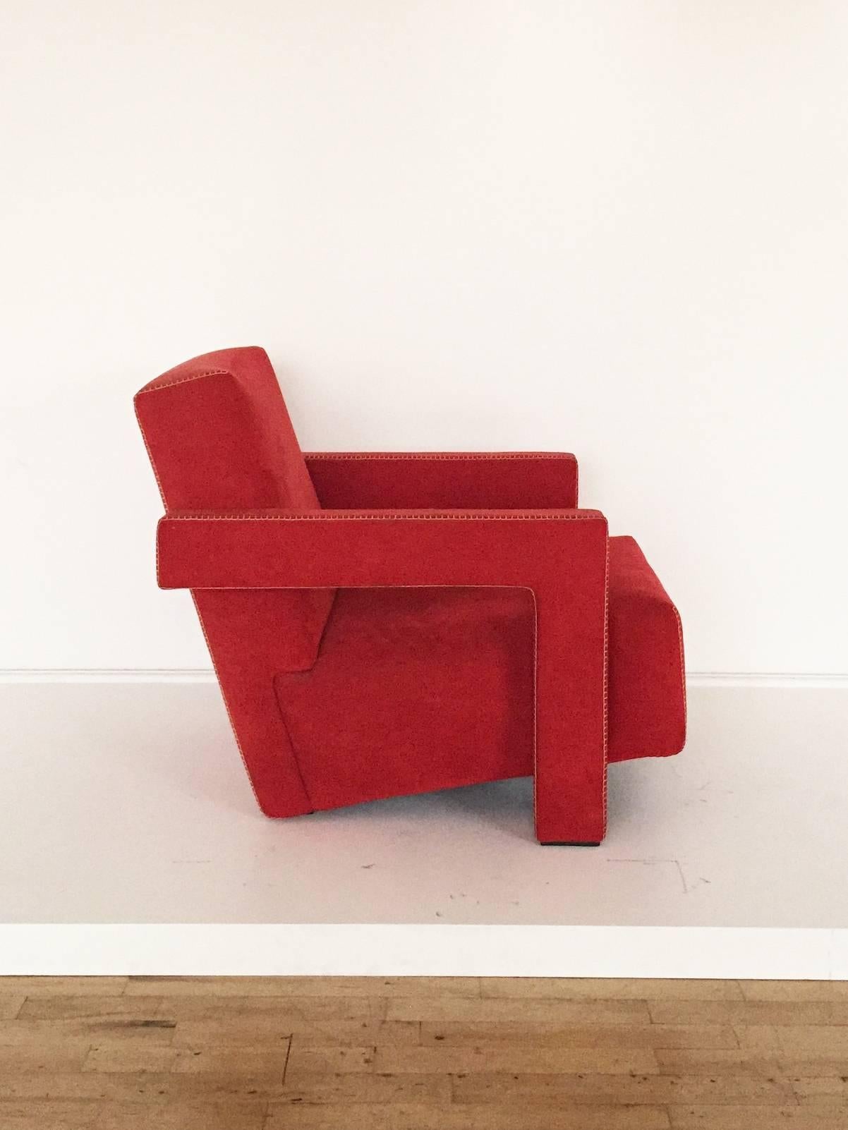 Early Cassina edition "Utrecht" chair by Gerrit Thomas Rietveld from circa 1988. In the original red suede upholstery with beige topstitching. Underside with numbered Cassina label.

From Cassina's website: "Rietveld, Dutch