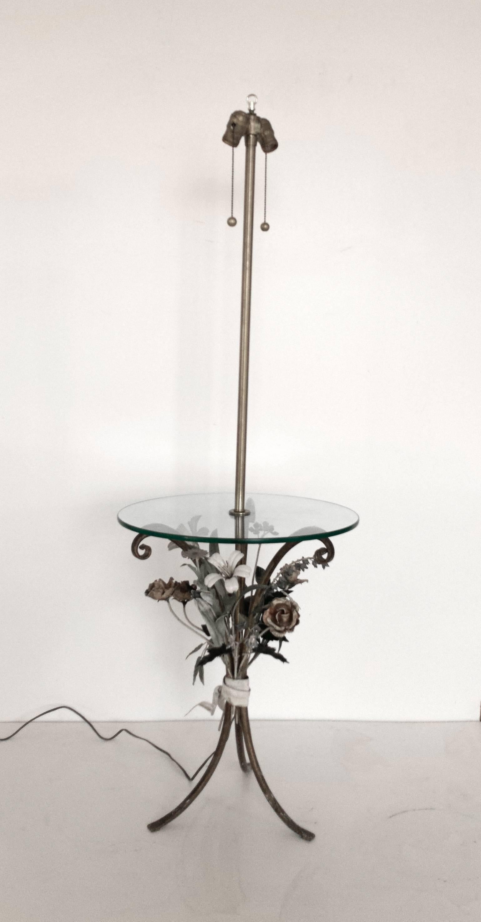 Beautifully-detailed, hand-painted metal floor lamp with incorporated circular glass side table manufactured by The Marbro Lamp Company of Los Angeles, CA. Stem of lamp in brass and base of metal tripod form with multi-color foliate tole detailing.