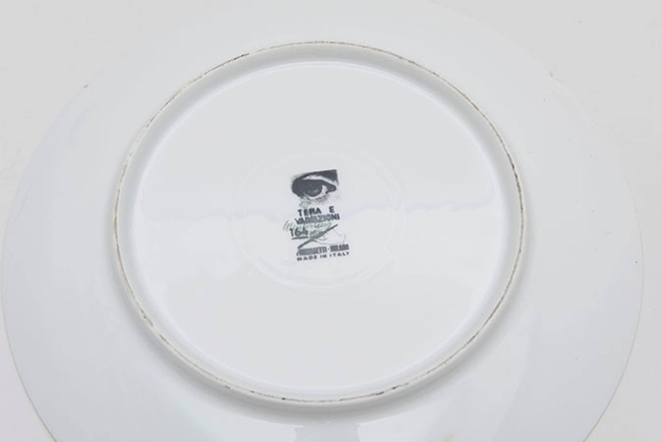 Early Themes and Variations plate designed by Piero Fornasetti. Fine white porcelain with black and white lithographic illustration. Underside of plate with 
