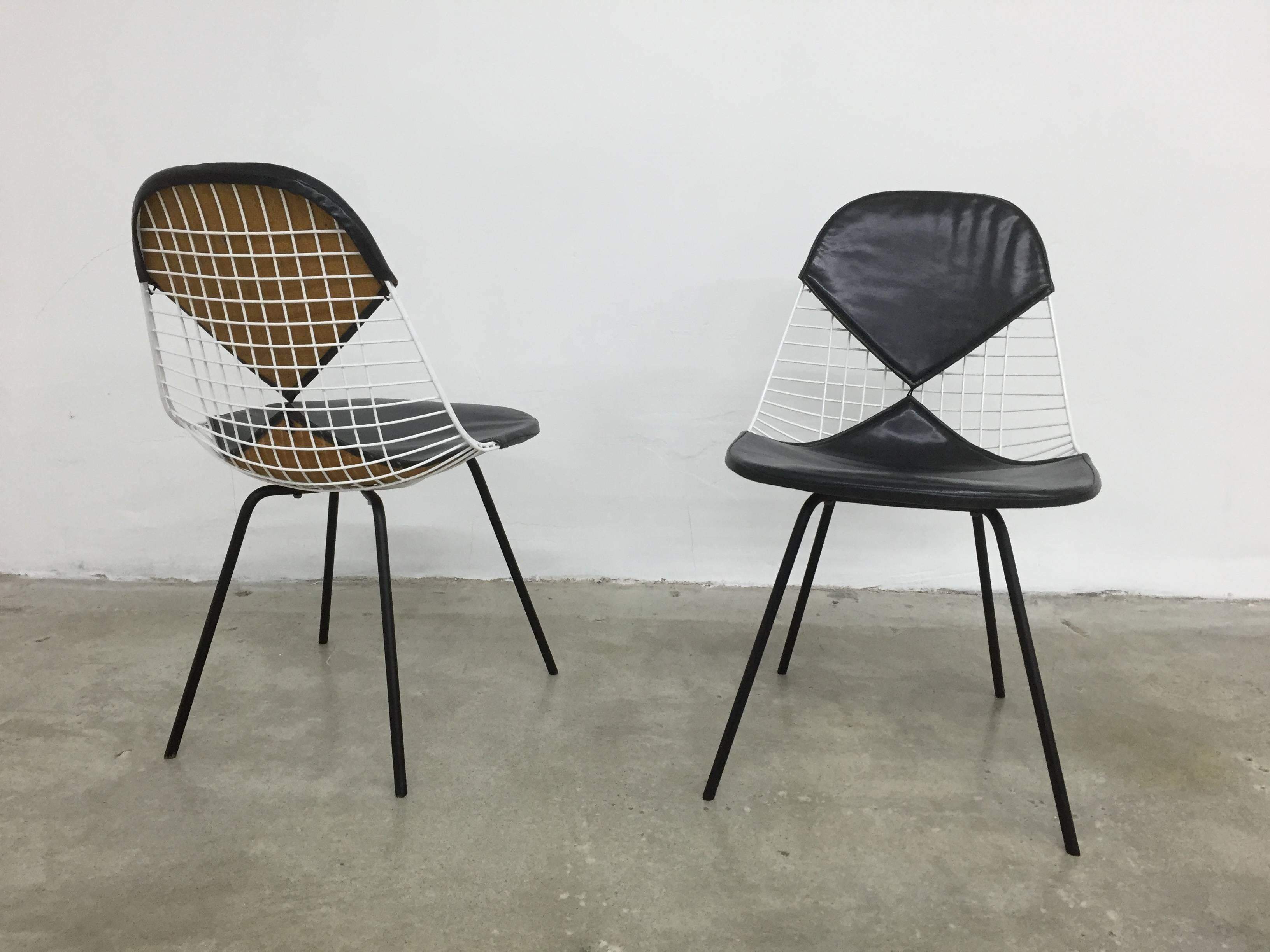 Great pair of early wire chairs, designed by Charles Eames and produced by Herman Miller. Each retains original 'bikini' seat cover with Herman Miller tag. Overall excellent condition, frames have been restored - recently painted and no broken