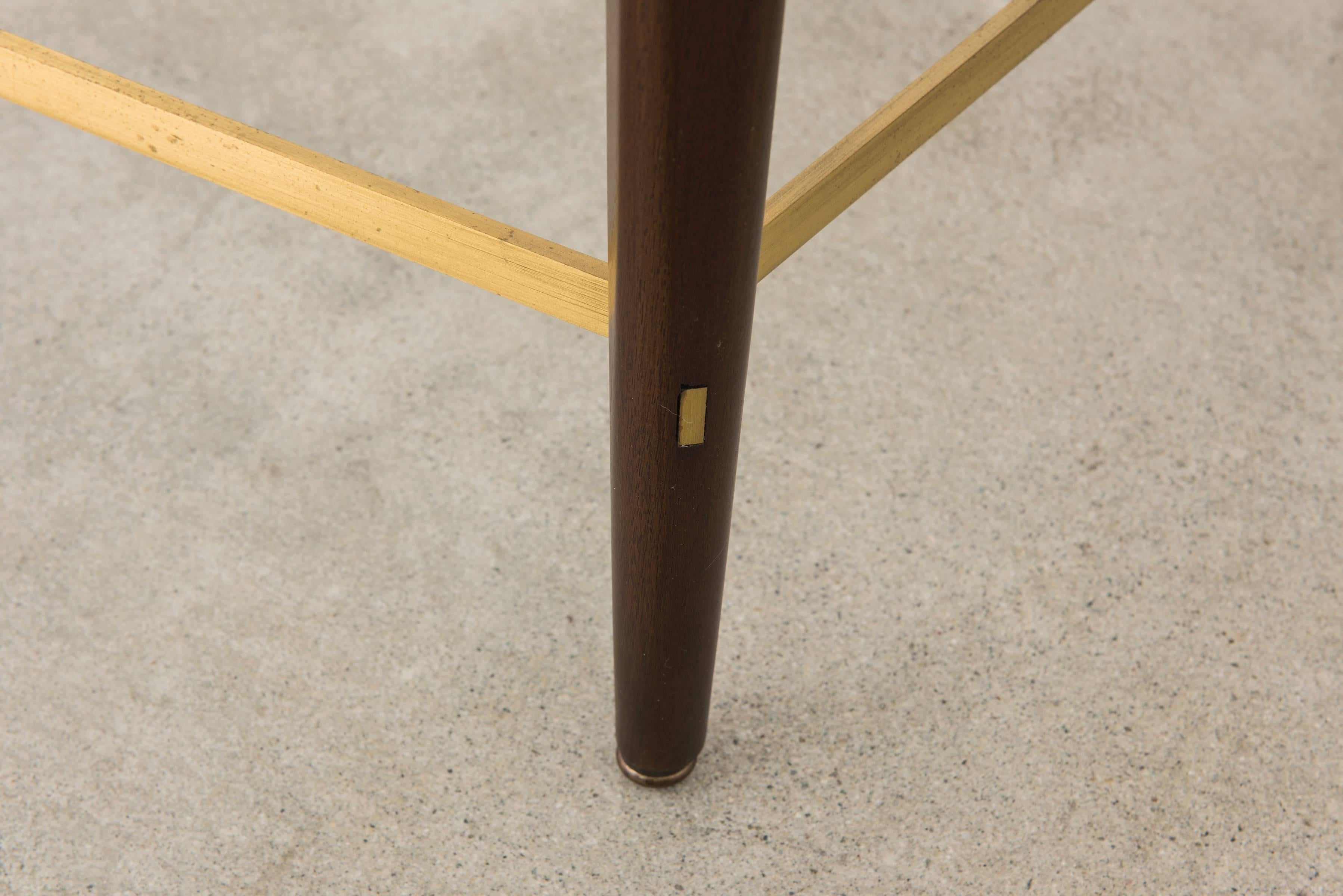 Dining table in mahogany stain with brass accents, designed by iconic American designer Paul McCobb and manufactured by Calvin of Grand Rapids, from the Irwin Group. Beautiful scale and proportion. Would fit four chairs around the table best without