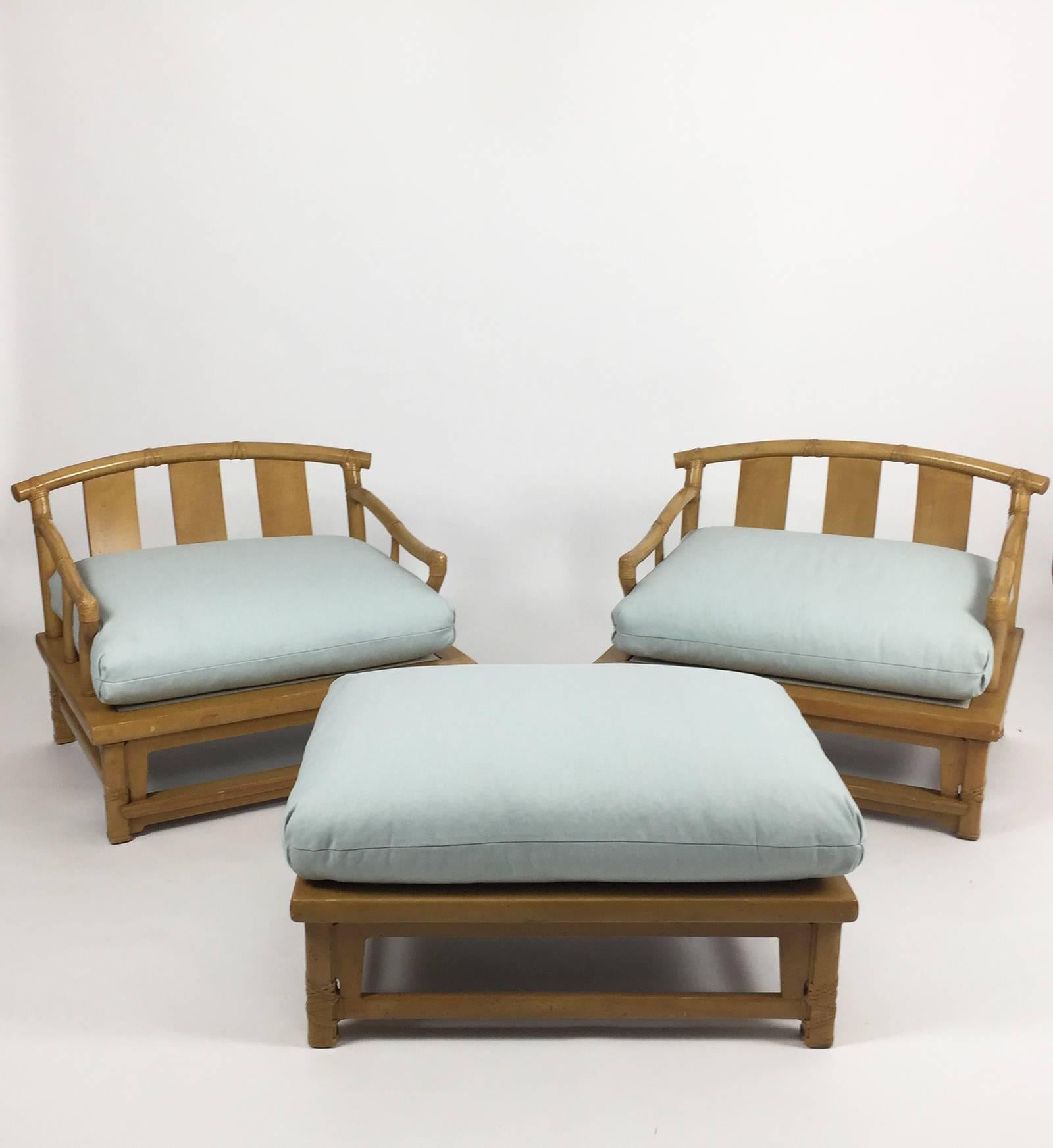 Oversized pair of yoke-back Asian style lounge armchairs and matching ottoman by Henredon from the 1990s. Executed in palm wood, in the bamboo style, with newly upholstered light blue cushions. Chinoiserie style. Made in the Philippines for