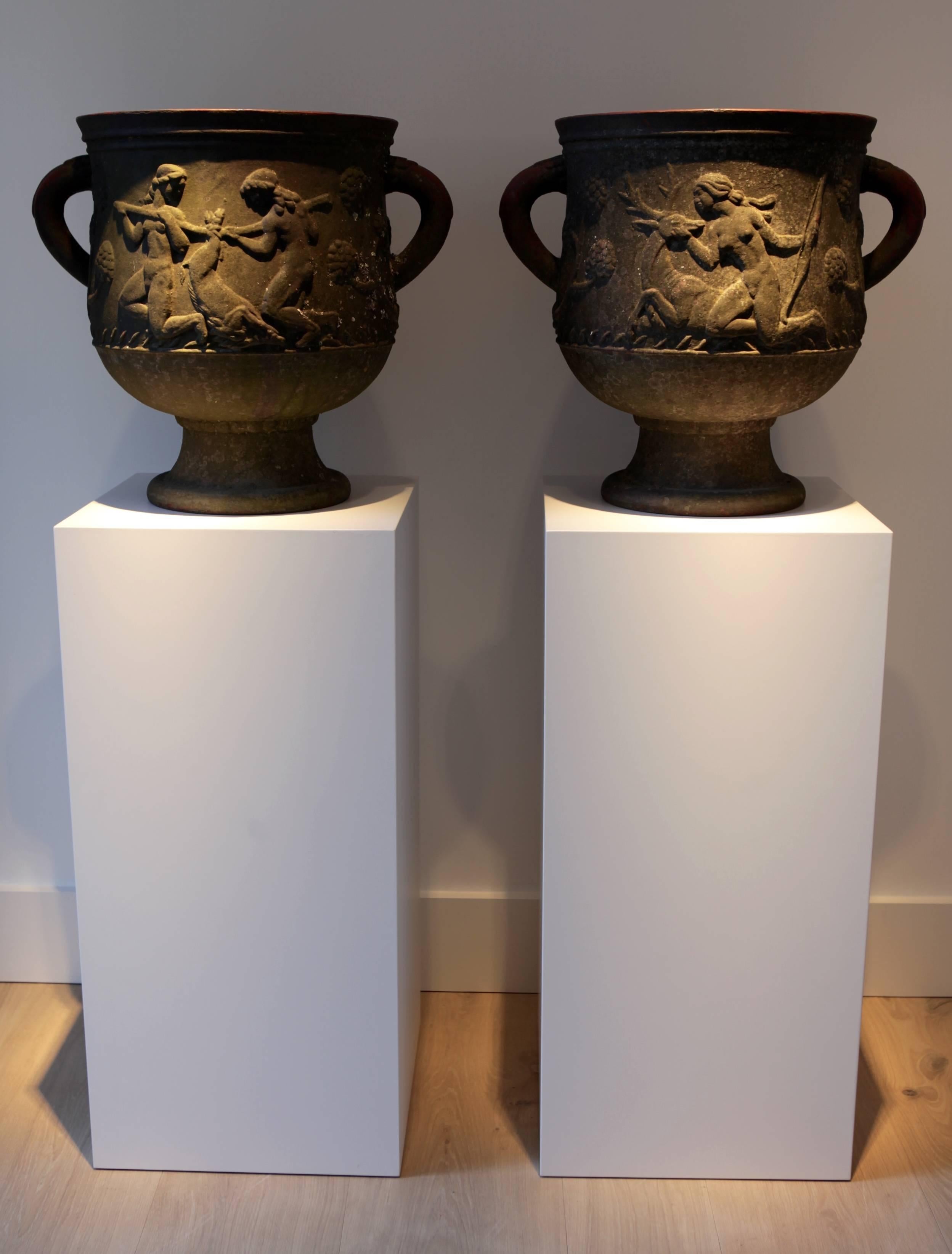 A pair of Ivar Johnsson (1885-1970) cast iron urns, Näfveqvarn,

Relief showing the hunting goddess Diana, 

signed, and dated, IJ 1919.
 