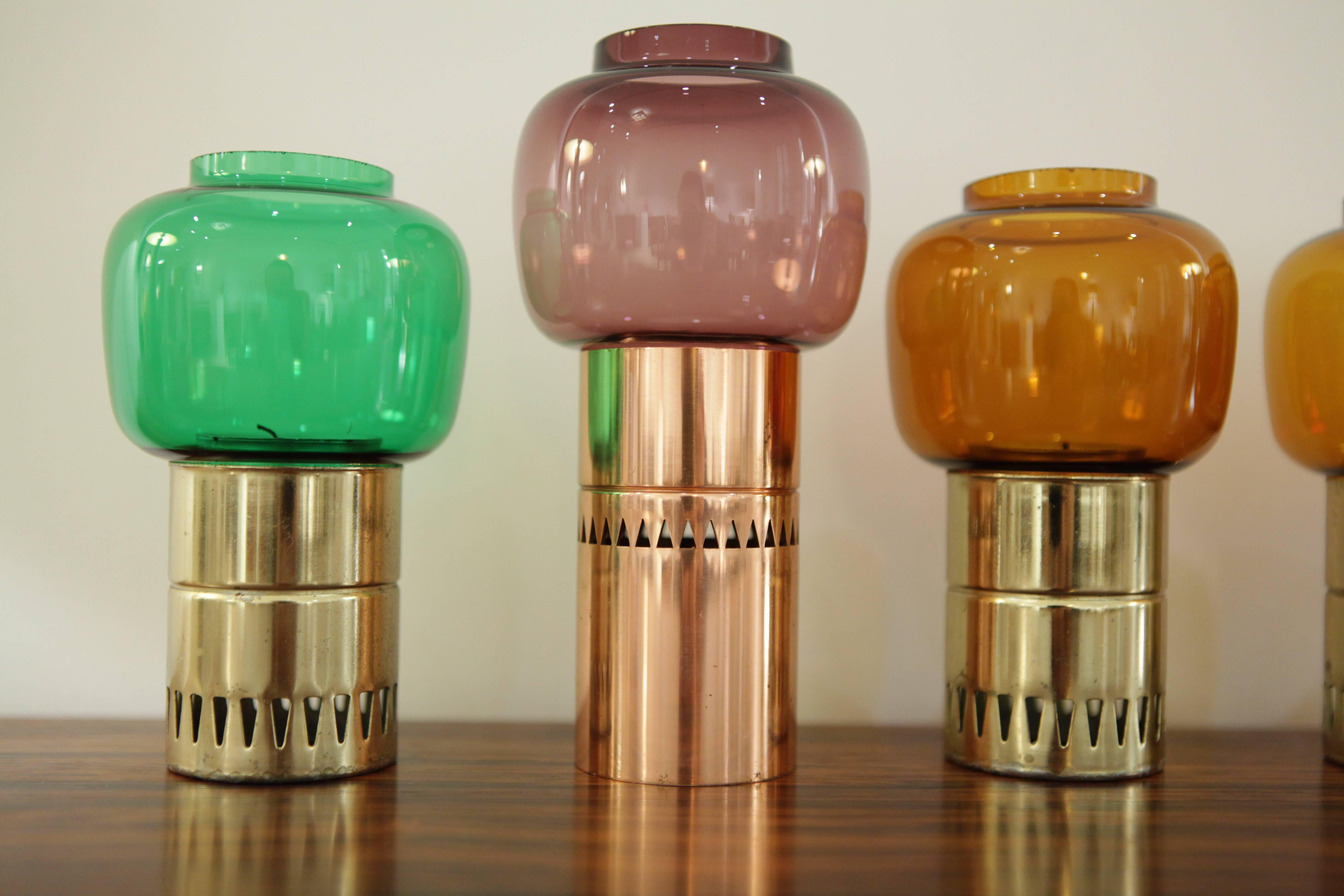 Hans-Agne Jakobsson, collection of eight candleholders,
colored glass, brass, copper,
manufactured by Markaryd,
Sweden.