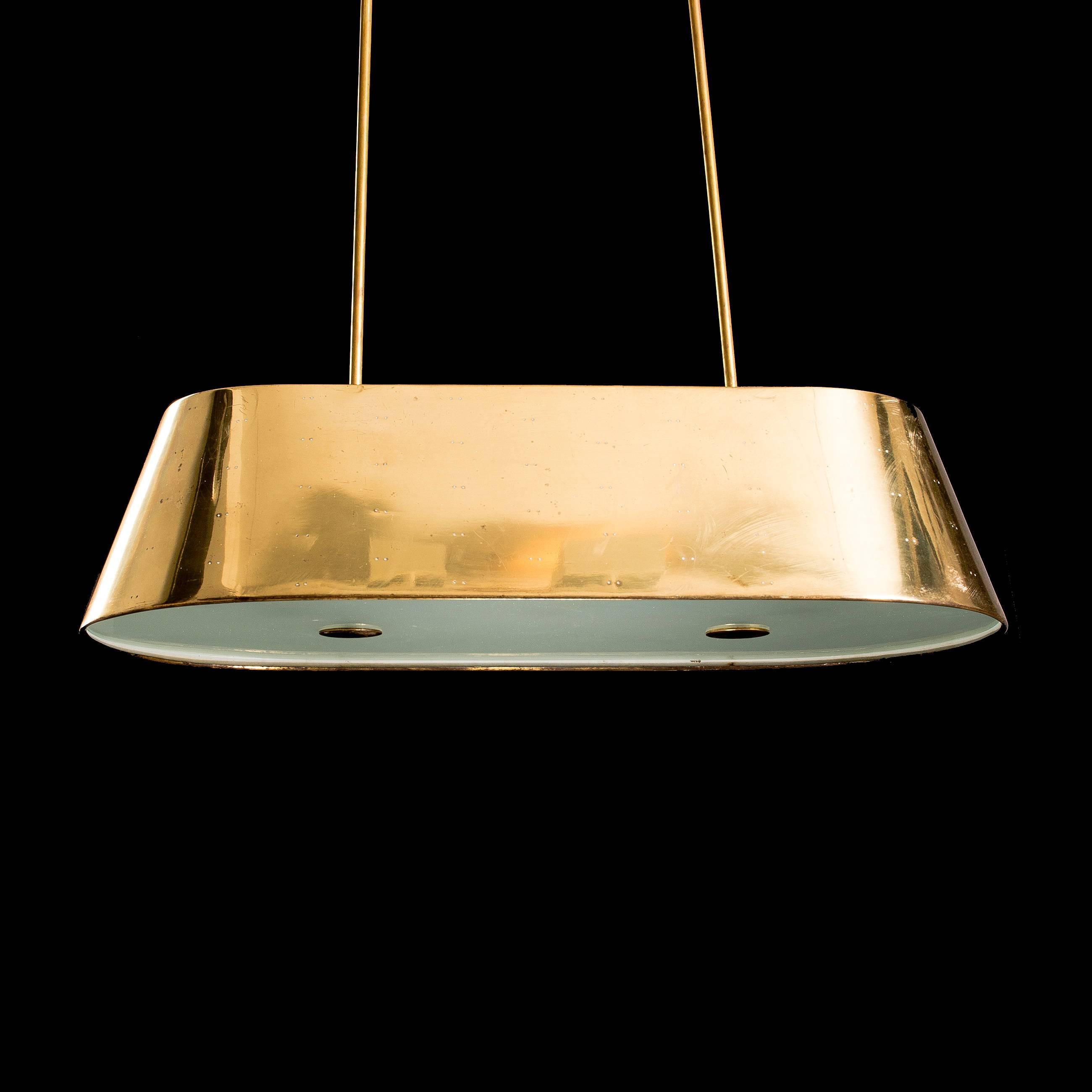 Rare and large Paavo Tynell ceiling light.

Perforated brass and glass.

All original.

Finland, 1950s.