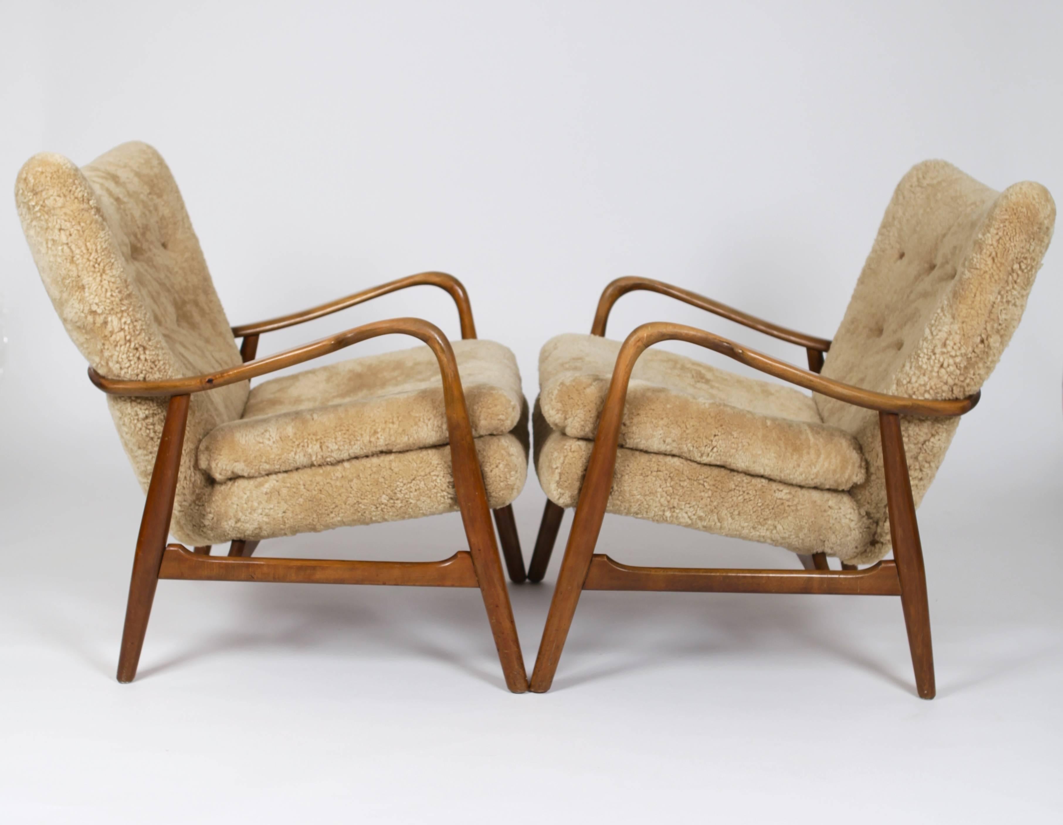 A pair of armchairs with one ottoman in stained beech and lambskin by
Acton Schubell & Ib Madsen, Denmark, 1950s
manufactured by Madsen and Schubell, Rungsted.