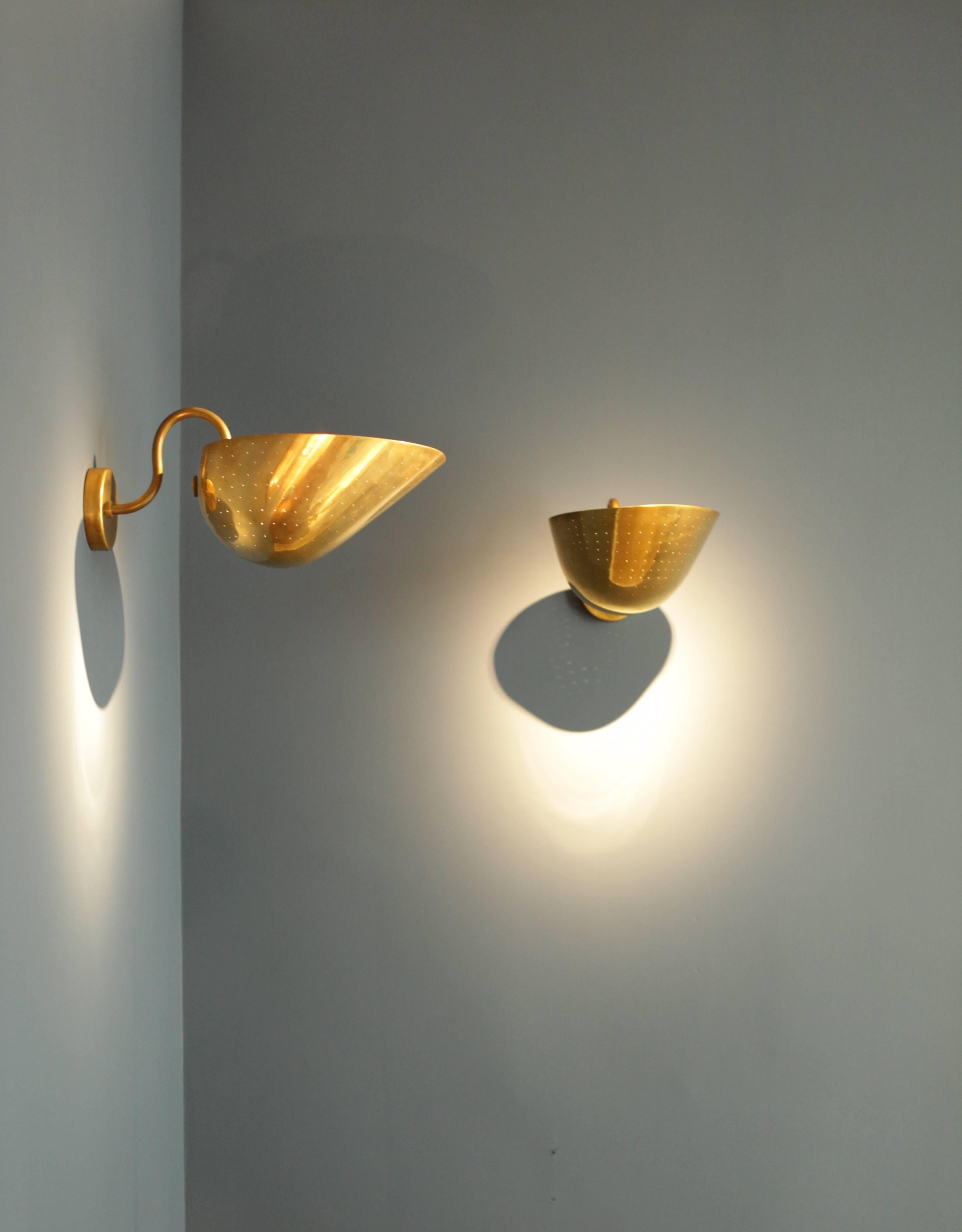 A pair of large and rare wall lights by the Swedish architekt and designer 
Carl-Axel Acking, 
Sweden, 1940s
Manufactured by Bröderna Malmströms Metallvarufabrik.
Perforated cup shaped brass shades,
Beautiful light distribution
Great scale.