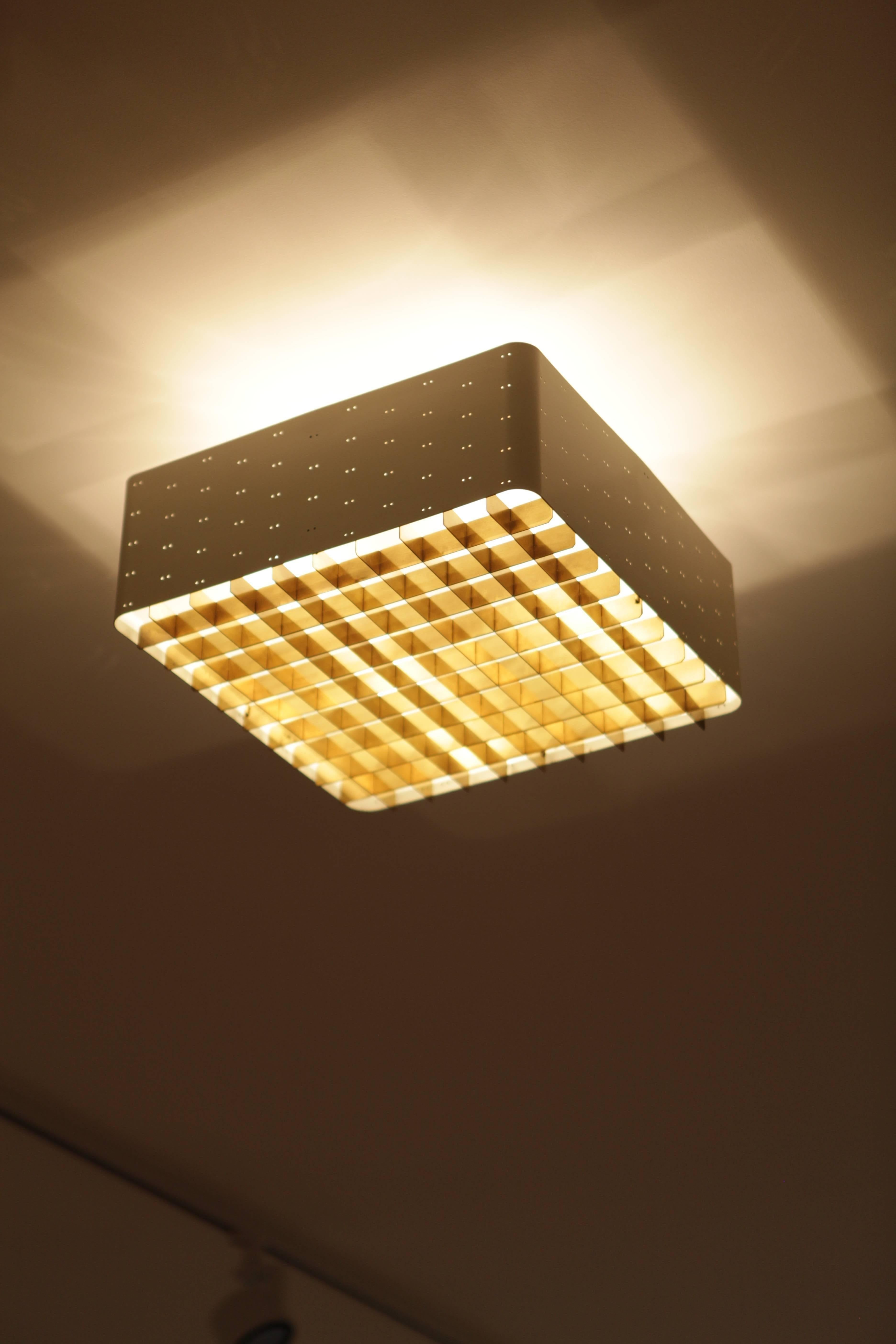 Paavo Tynell, white perforated,enameled metal, brass grill and frosted glass ceiling light
mod.9068 
manufactured by Idman Oy,
Finland 1950s.