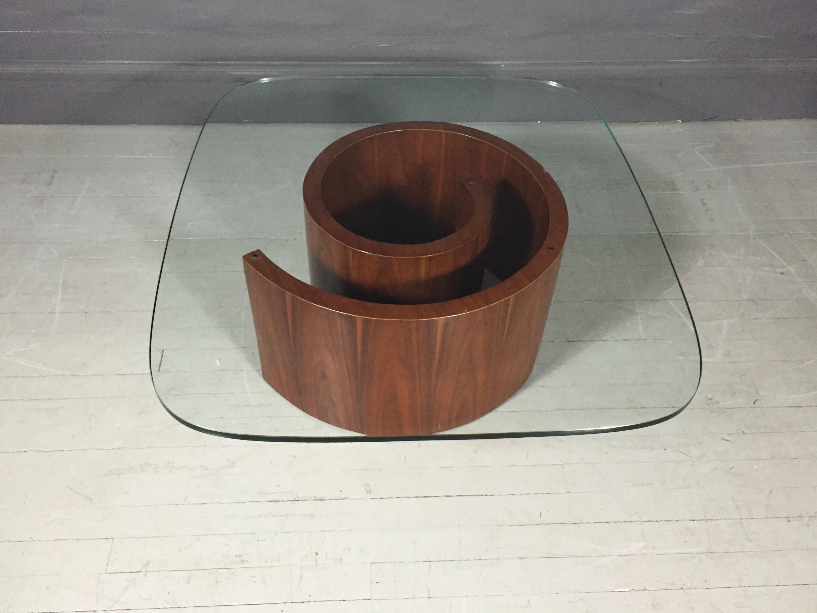 A classic piece of American modern design, the Snail table by Vladimir Kagan designed in 1954 for Selig Furniture Company. Lightweight circular base in walnut veneer belies it's strength - holding original heavy curved-edge rectangular glass top.
