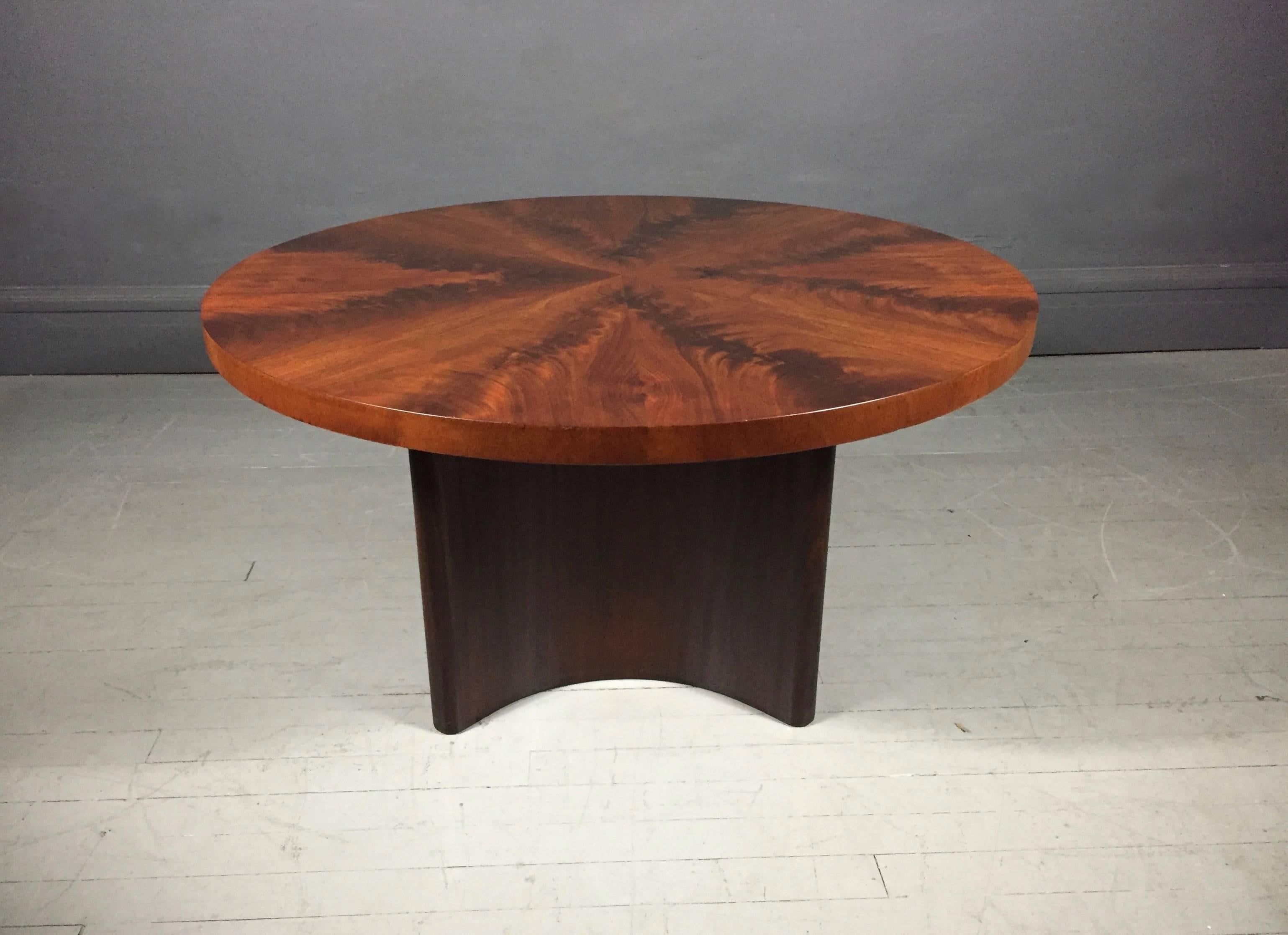 Architecturally beautiful coffee table with well placed perfect four-section crotch mahogany veneer top and four-part curved walnut base. By Mjolby Intarsia, Sweden. Dated at bottom 8.29.1940 and marked with three crowns, R and Mjolby.