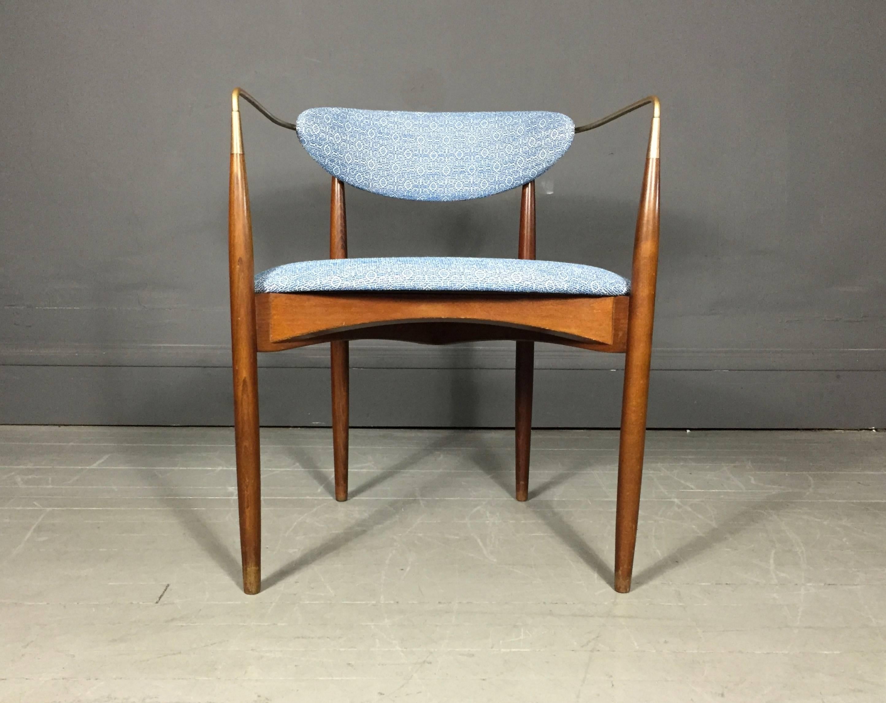 An iconic dining or side chair by the talented Dan Johnson for Selig with Walnut frame, elegant brass wrap arms, floating seat back and wishbone back leg construction - updated with a beautiful patterned fabric, USA, 1950s. Light scuffs to finish at