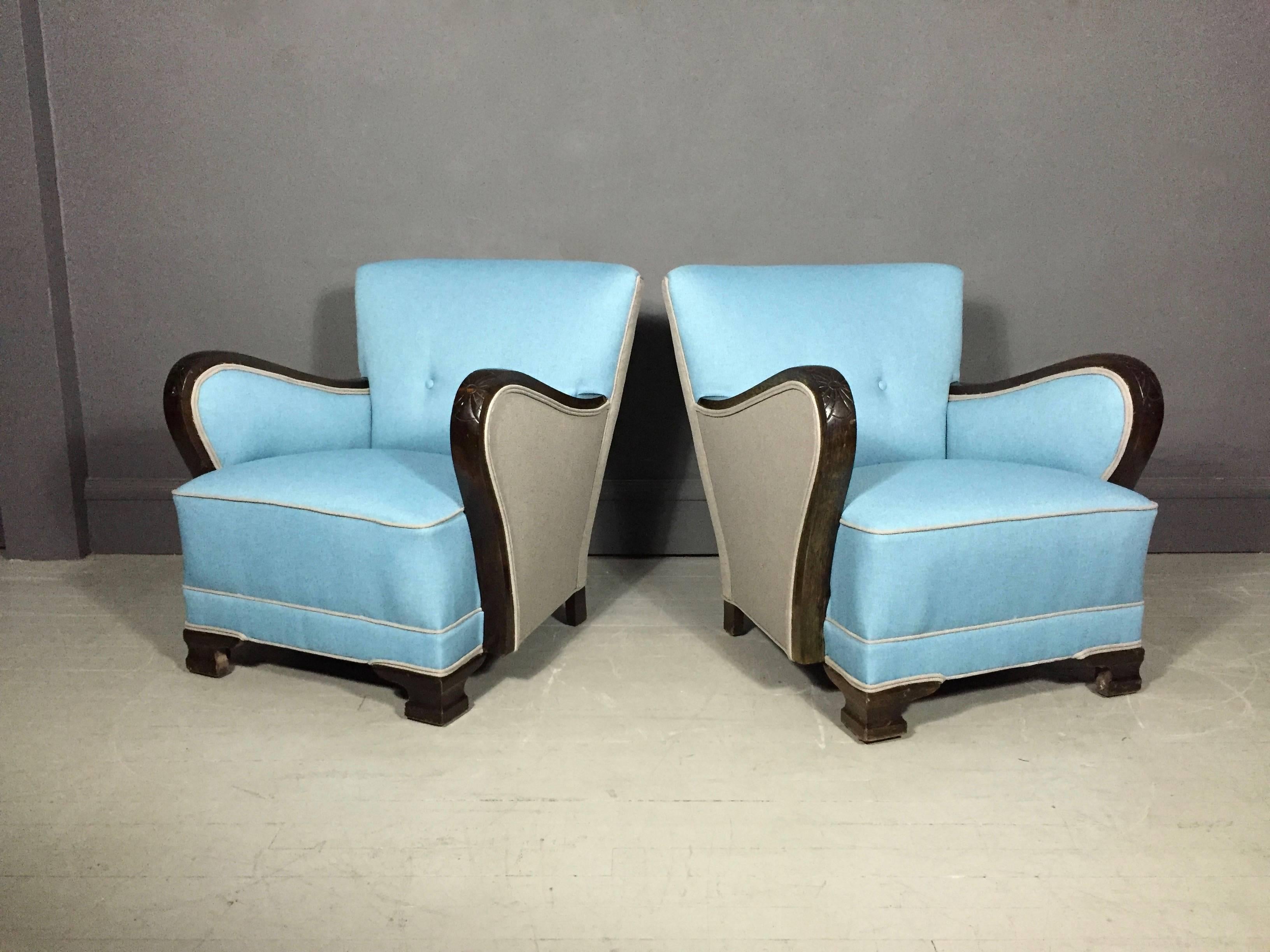 Wonderful profile for these early 1930s club chairs, with hand-carved and decorated mahogany arms. Recently updated with a gorgeous Maharam two-tone fabric and contrasting piping. Possibly Danish.