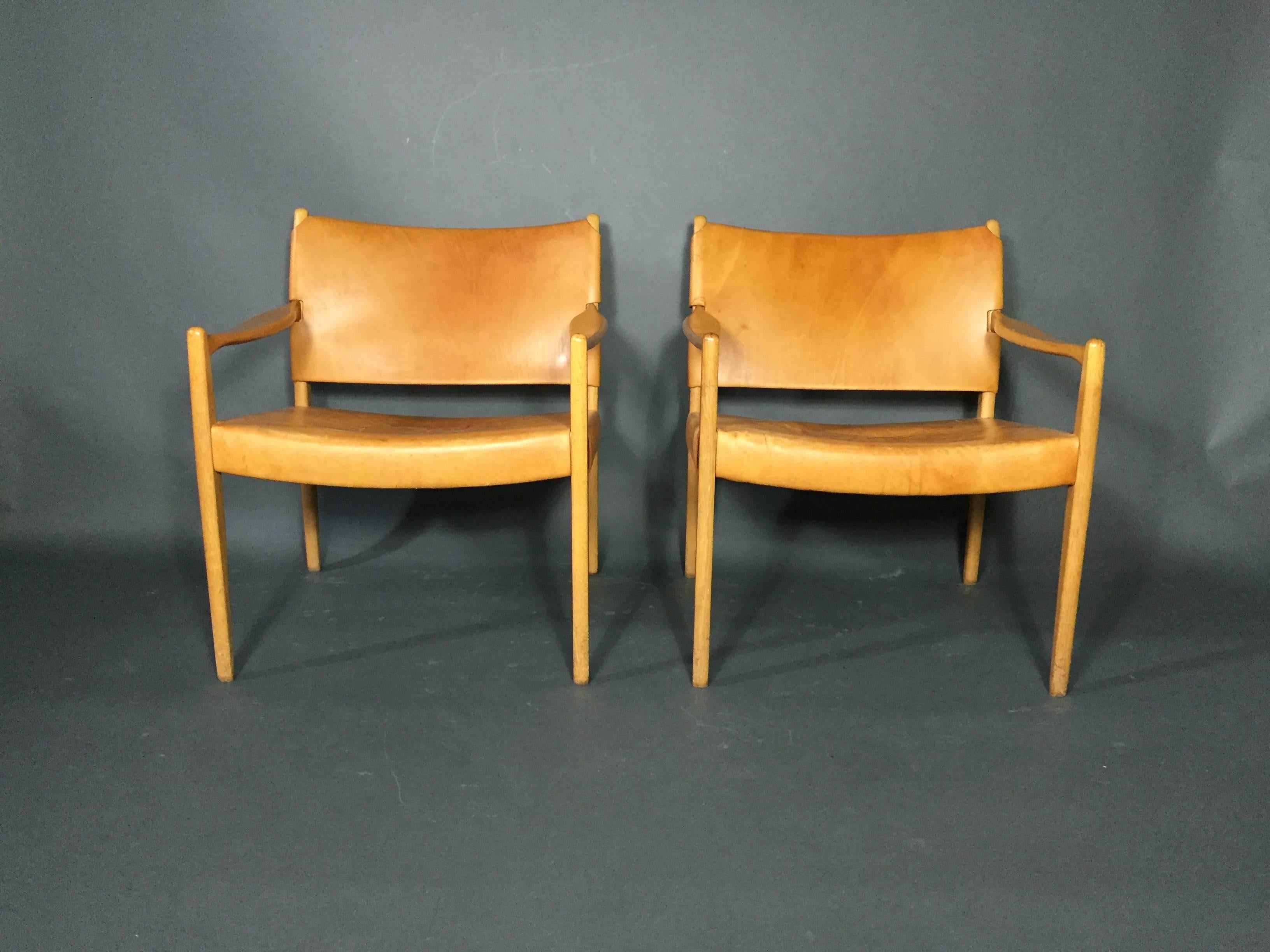 Elegance and scale with these simply beautiful armchairs in light brown/tan saddle leather on oak frames, model Premiär by Per-Olof Scotte for Ikea, Sweden, late 1950s.

Sold individually only ONE available. Minor staining to seats - though