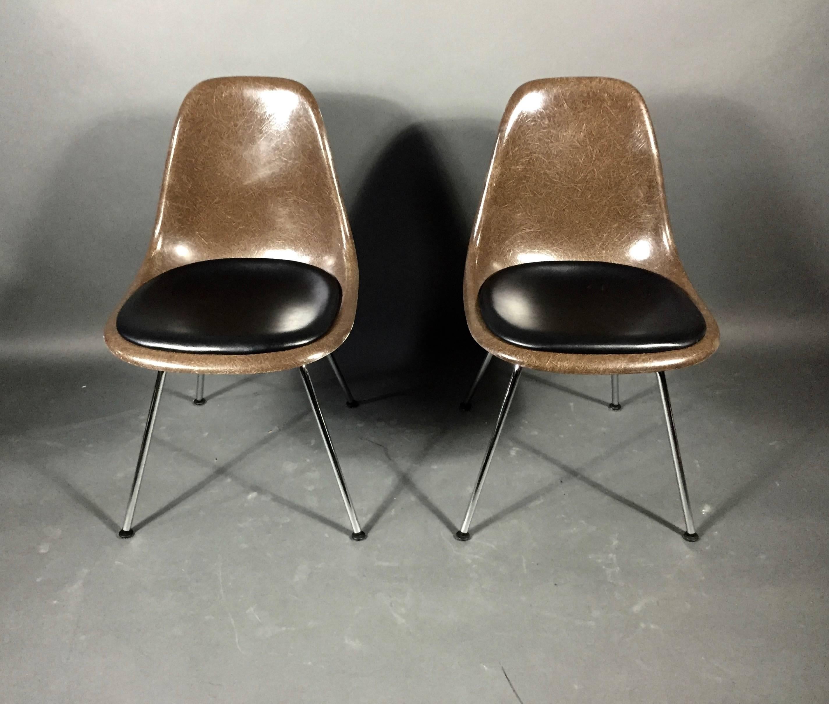 One of my favorite chairs made better. Original molded brown fiberglass shell chairs by Charles and Ray Eames (designed 1948) produced by Herman Miller. Professionally updated with Switzerland-based Vitra Steel-H bases and cushions upholstered in