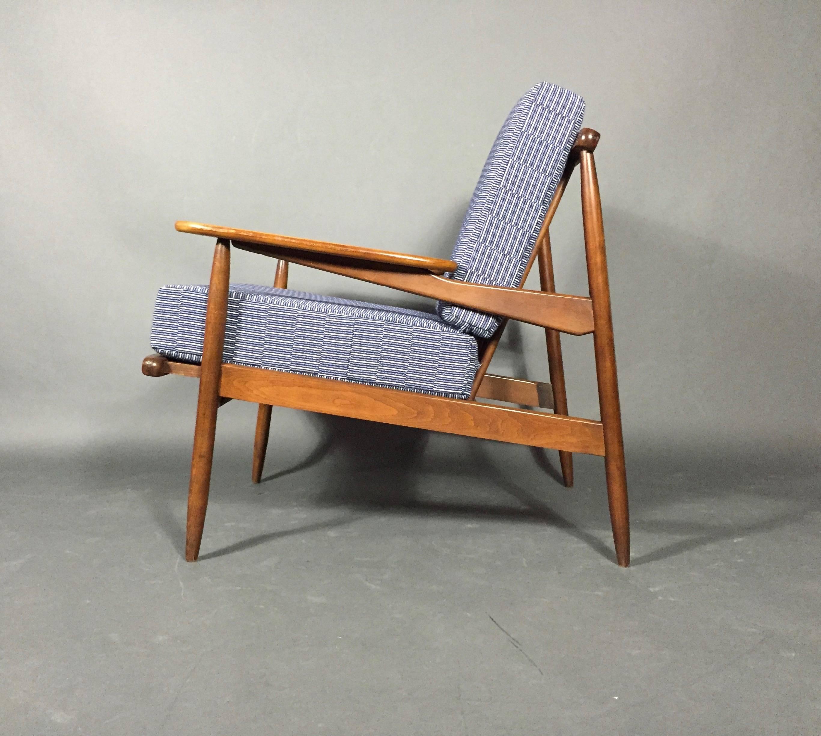 A terrific combination of sleek Mid-Century, American walnut lounge chair with new cushions covered in the amazing upholstery fabric out of England by Eleanor Pritchard using Sottish wool, loomed in Wales. Stunning fabrics.