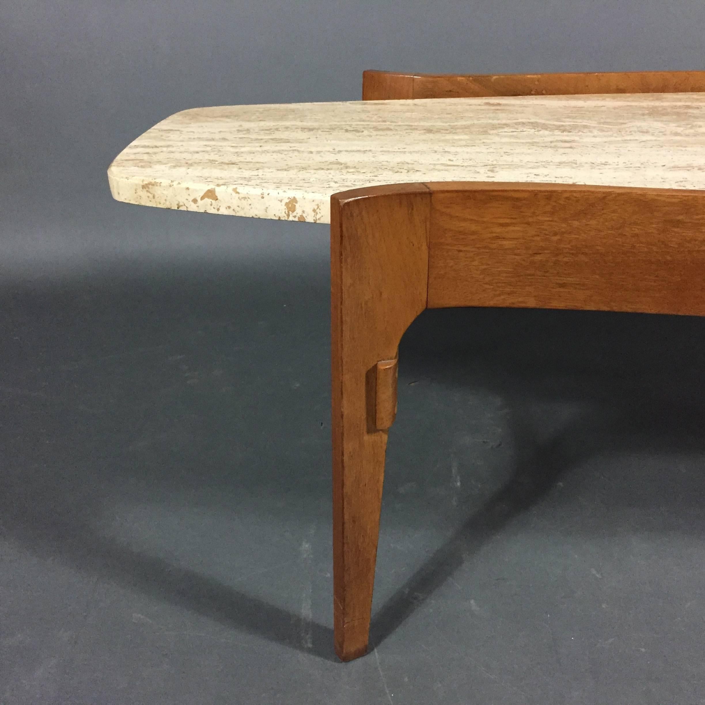 A delicious curved walnut frame supporting a wonderful and solid Italian travertine coffee table top - simplicity of design at its chic best. Unattached top floats beautifully over frame. Made by Walker Zanger for Gordon's Furniture, USA, circa