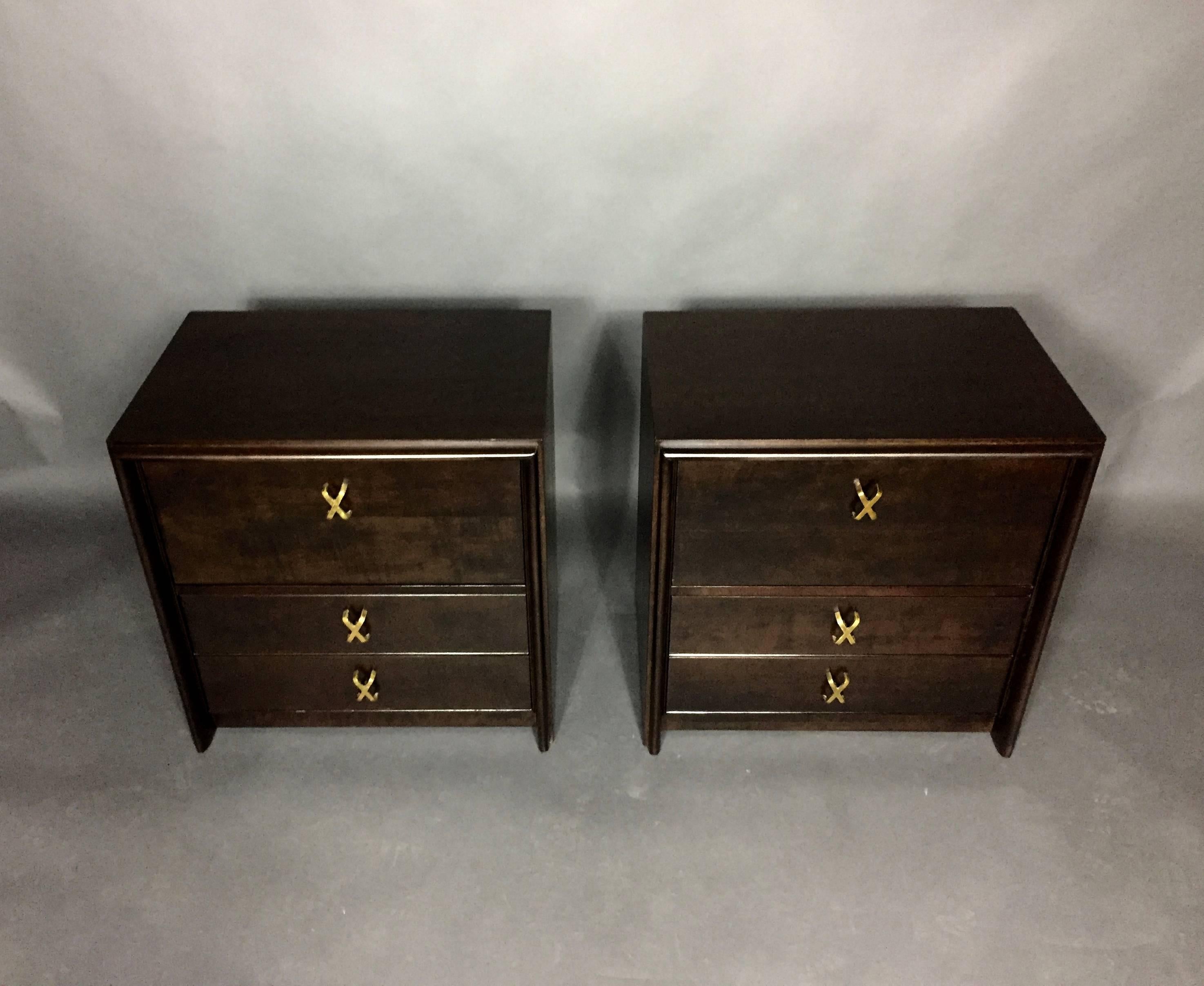 This pair of lacquered birch nightstands were recently refinished in a gorgeous black stain over the original light birch finish, showing a perfect and rich brown visual. Iconic brass X-drawer pulls. Each chest has a drop-down top-front drawer over