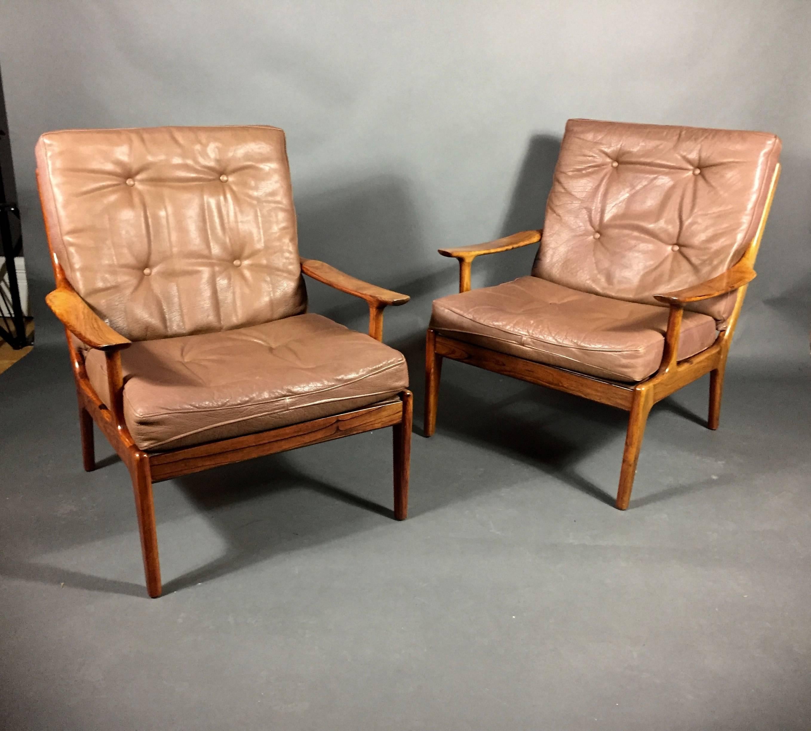 Beautiful proportions and simplicity of lines on these solid rosewood frames are covered in a heavy patinated and buttoned leather. Danish design, circa 1970. Rosewood finish lighter than original though consistent overall to visible frame.
