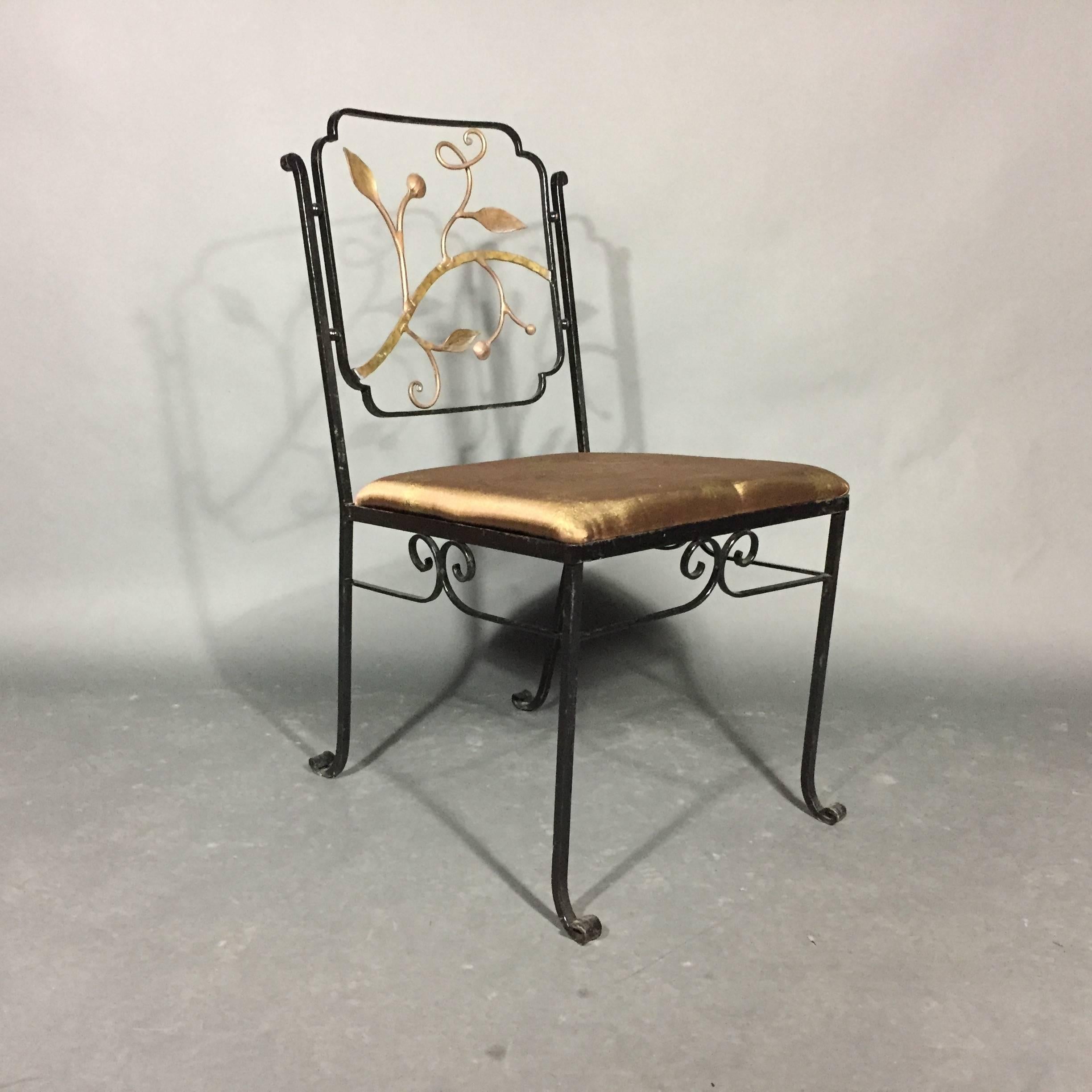 Set of four exceptional quality Art Deco era iron garden chairs with handcrafted bronze vine and leaf seat backs. Wonderful scroll work to sides and feet. This set is 1920s or early 1930s in excellent condition, possibly Salterini but more likely be