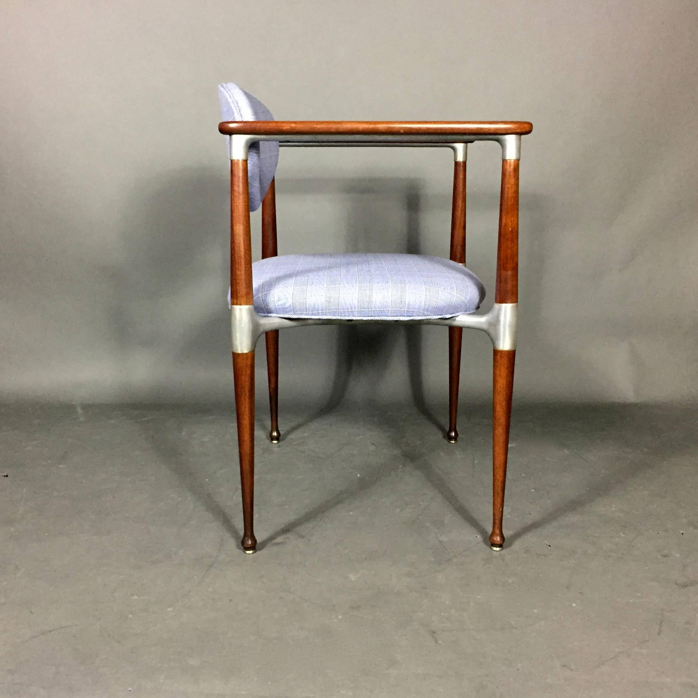 Pair of architecturally beautiful chair design by Dan Johnson attributed likely for Selig, USA, 1960s. Polished and nicely tapered walnut frames are accented with aluminium and tilt function seat back. Recently updated with a vibrant blue men's