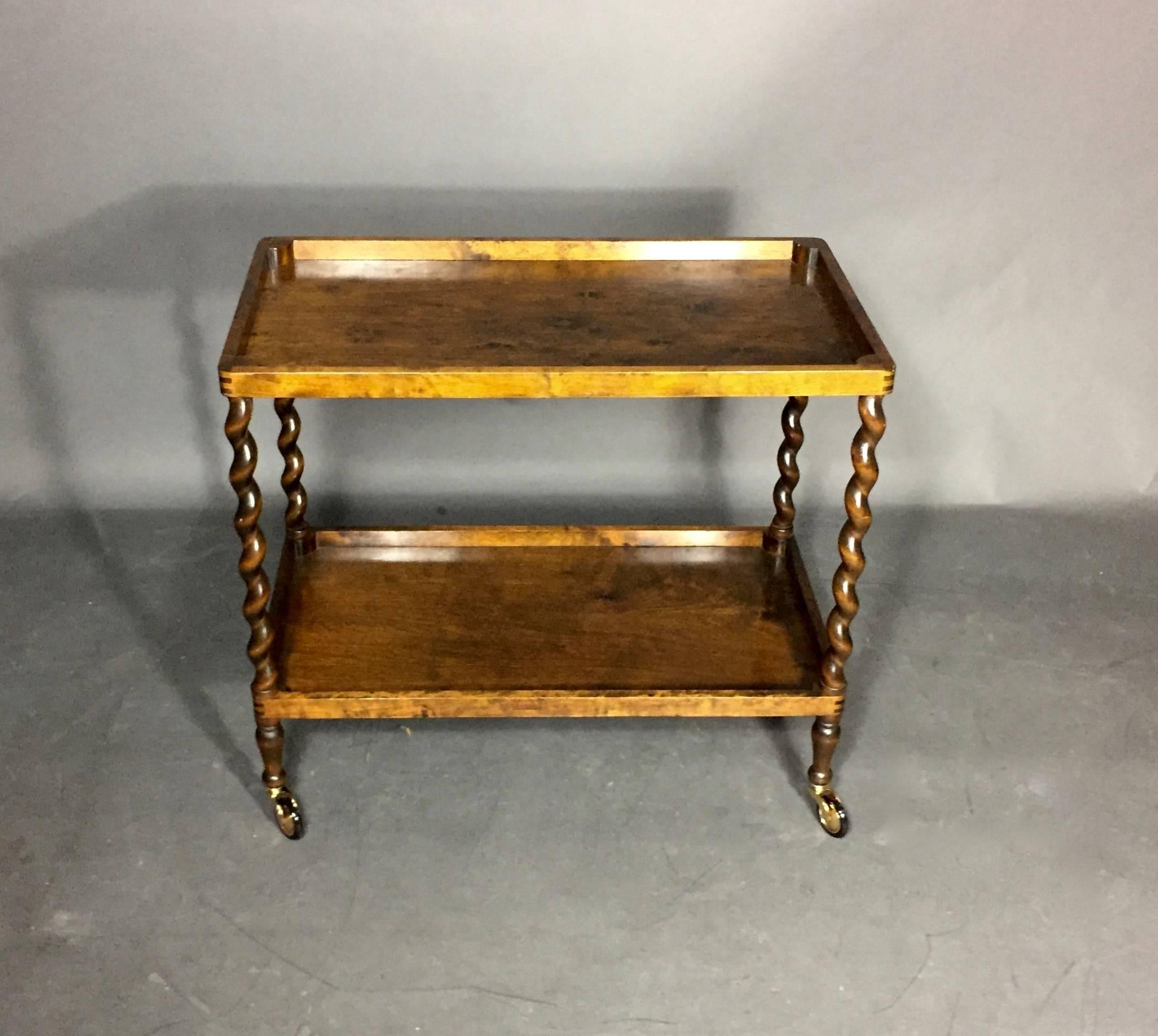 Clean and fresh lines of this simple mahogany drinks trolley with beautifully turned spiral legs that make the piece elegant and warm. Nicely curved corners and a lower repeat shelf. Newly updated brass wheels.