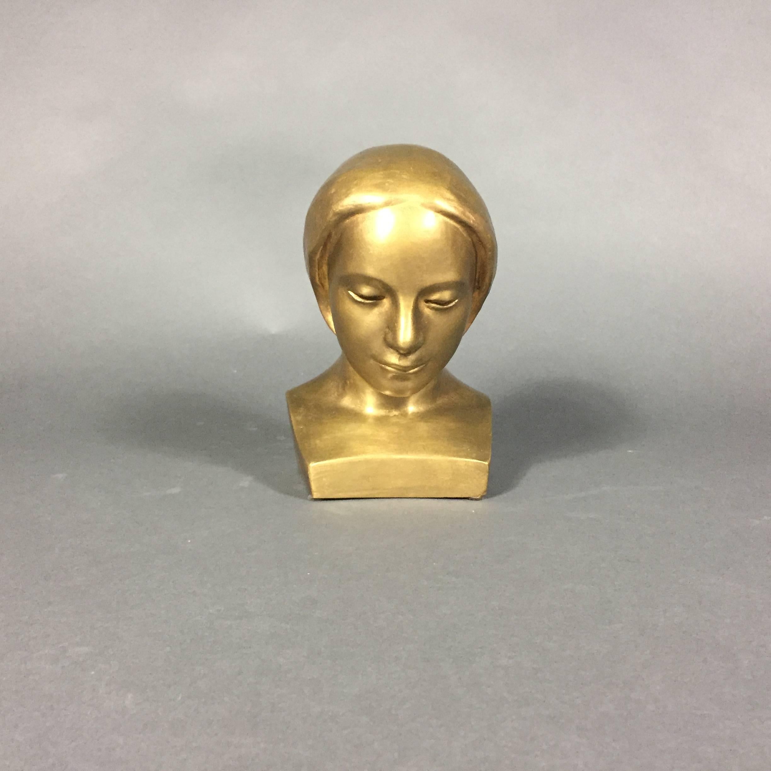 A wonderful gold painted bronze bust of a young woman, demure in aspect - calming and transcendent.  Completed by Swedish artist Curt Hansson (1907-1980), Sweden.  Initialed and dated on side CH 53.