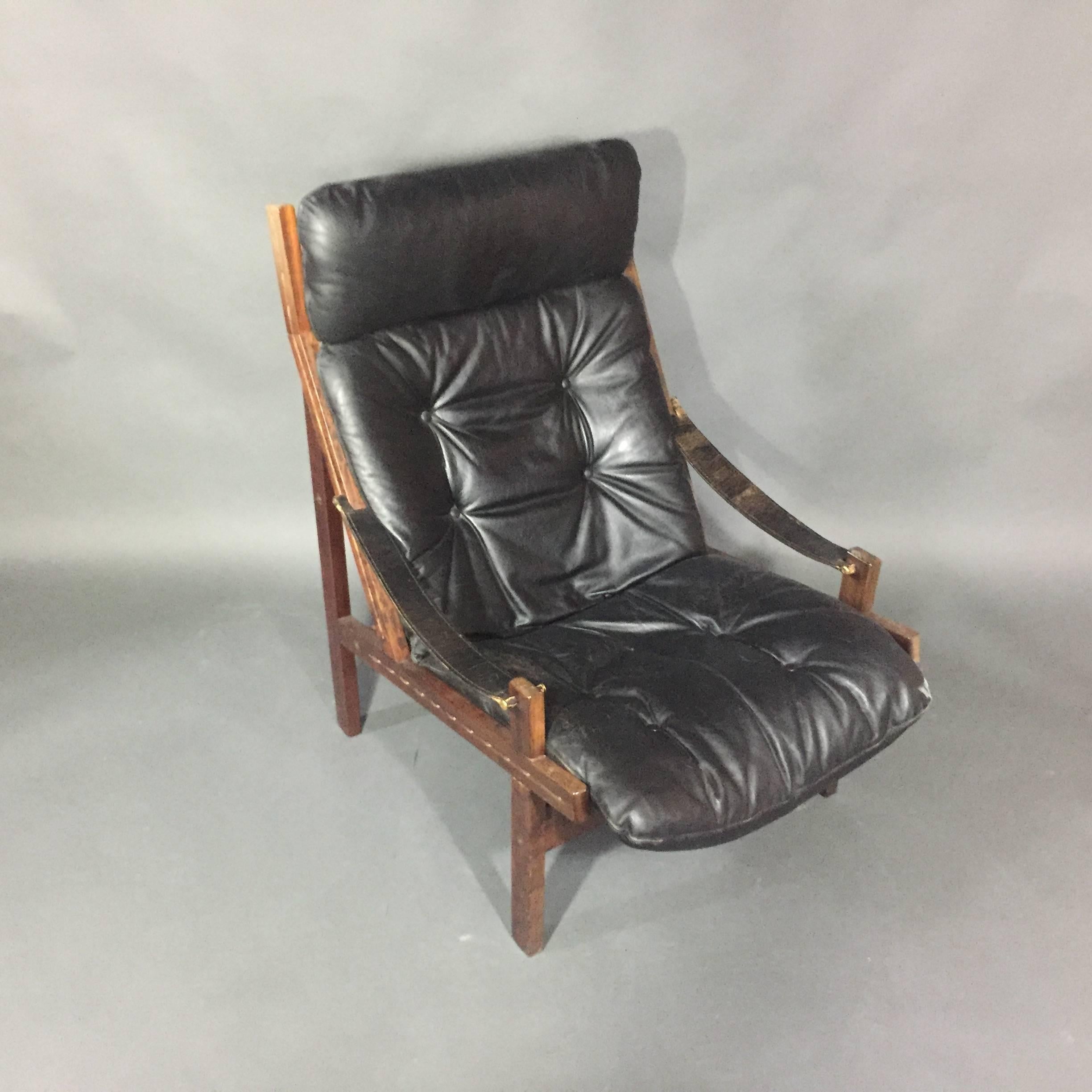 In the safari chair tradition, this high back version in black leather was called 
