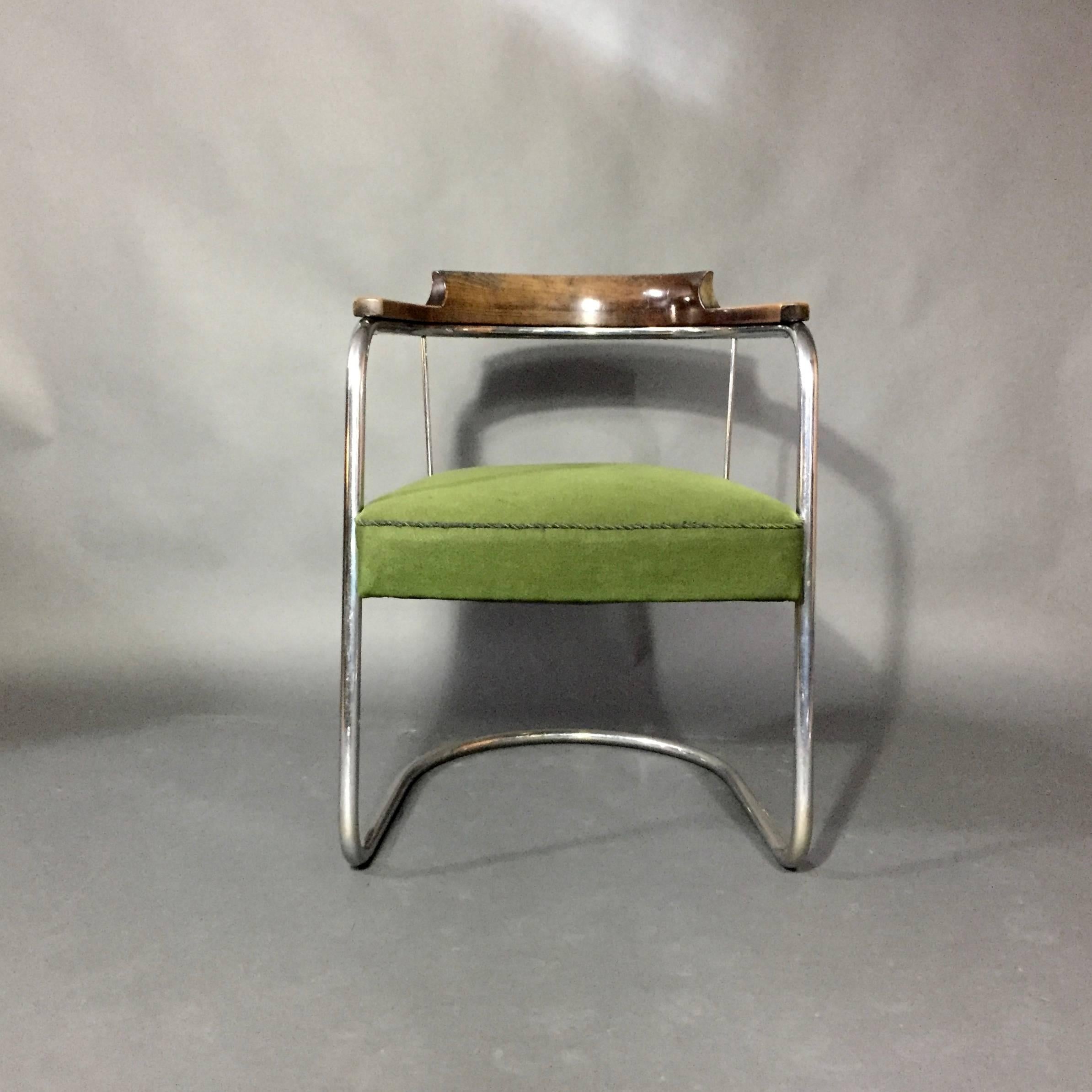 From the Bauhaus era, either Scandinavian or Continental from the late 1930s.  Exceptional design with beautifully lacquered carved back and arms supported on tubular chrome base.  A perfect desk or side chair with a nice forest green upholstery. 