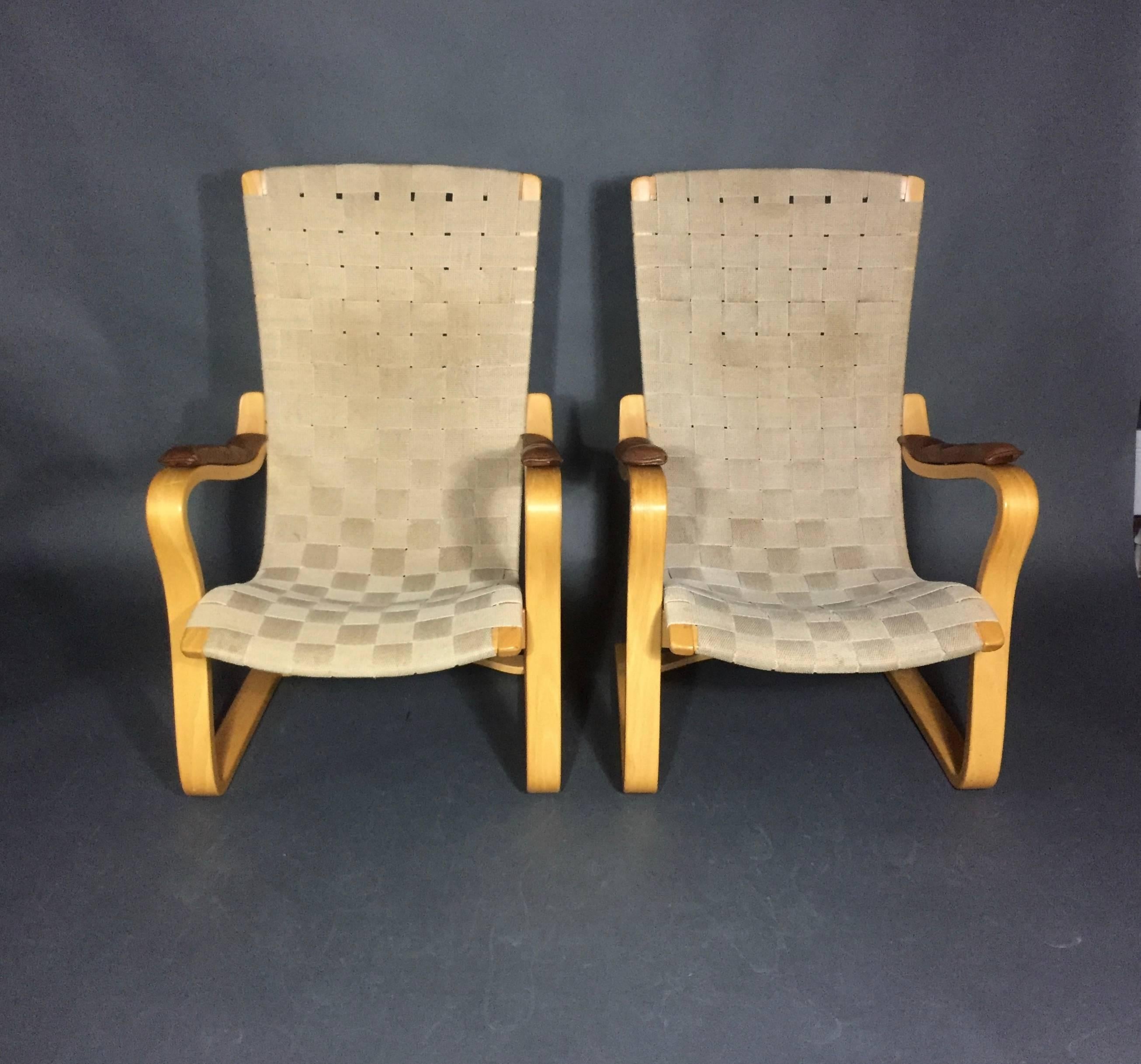 The original model Patronen was created in the 1940s by Gustaf Axel Berg. This later production in laminated birch bentwood was made in 1970s for Bröderna Andersson with original hemp webbing and sculpted leather armrests. Each chair marked at back