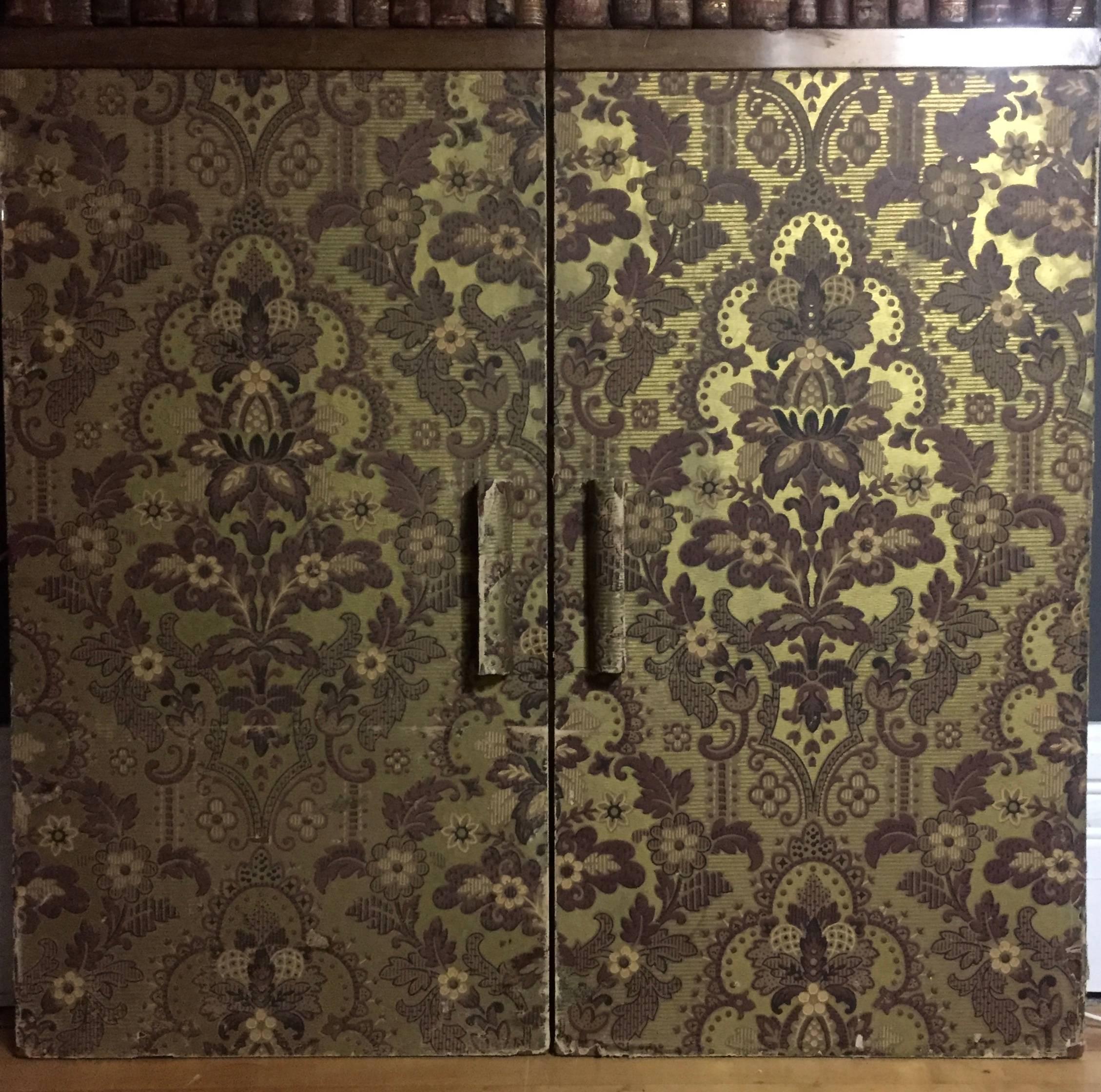 A pair of moody and decorative door panels circa 1900 or earlier constructed in wood that are each 58