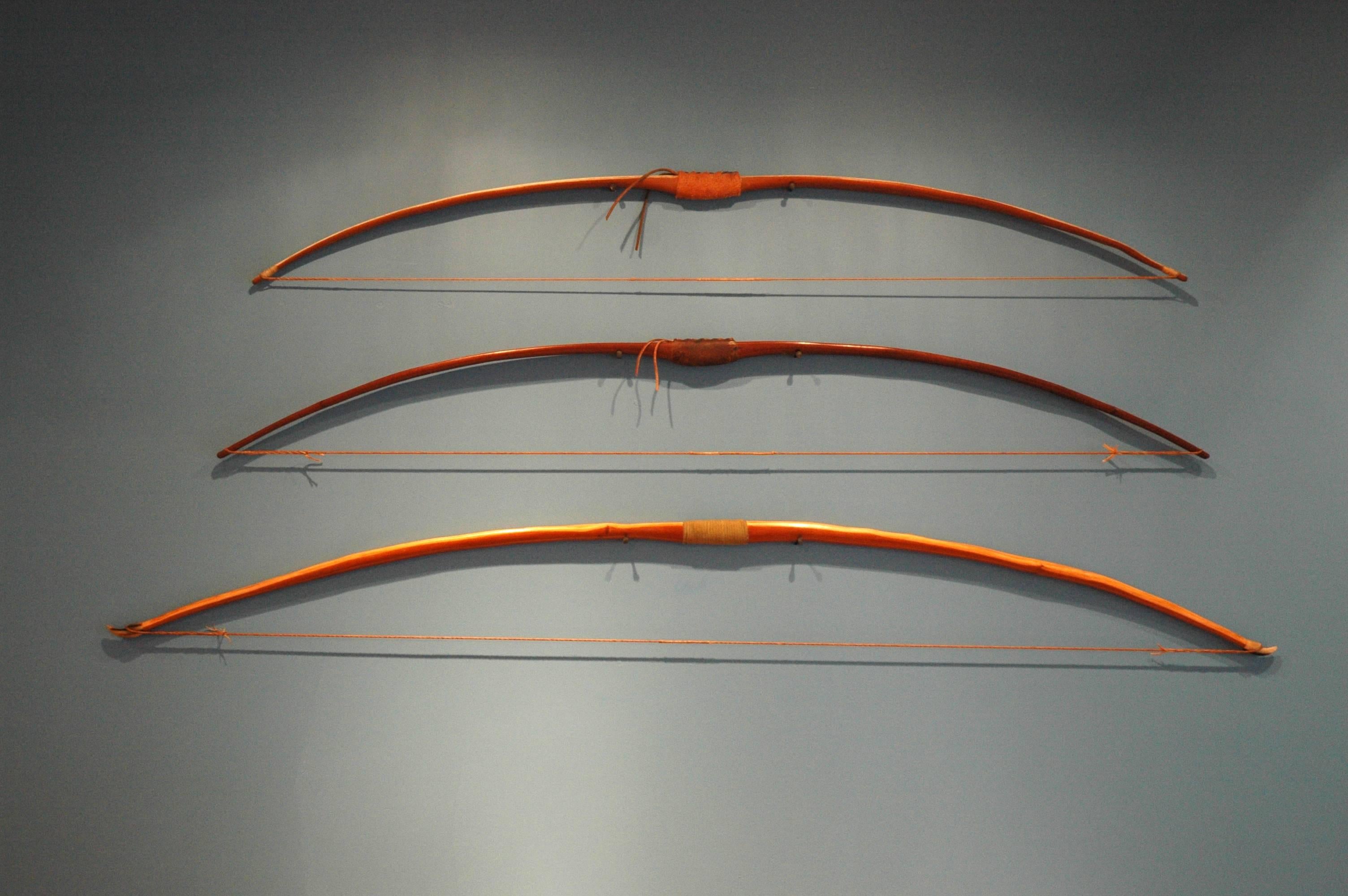 An amazing group of three one-of-a-kind bows made in the traditional technique by artist Daniel Oates in his Sharon CT studio.

English longbow is made of Pacific Northwest Yew from Oregon with cow horn tips, artificial sinew string and velvet