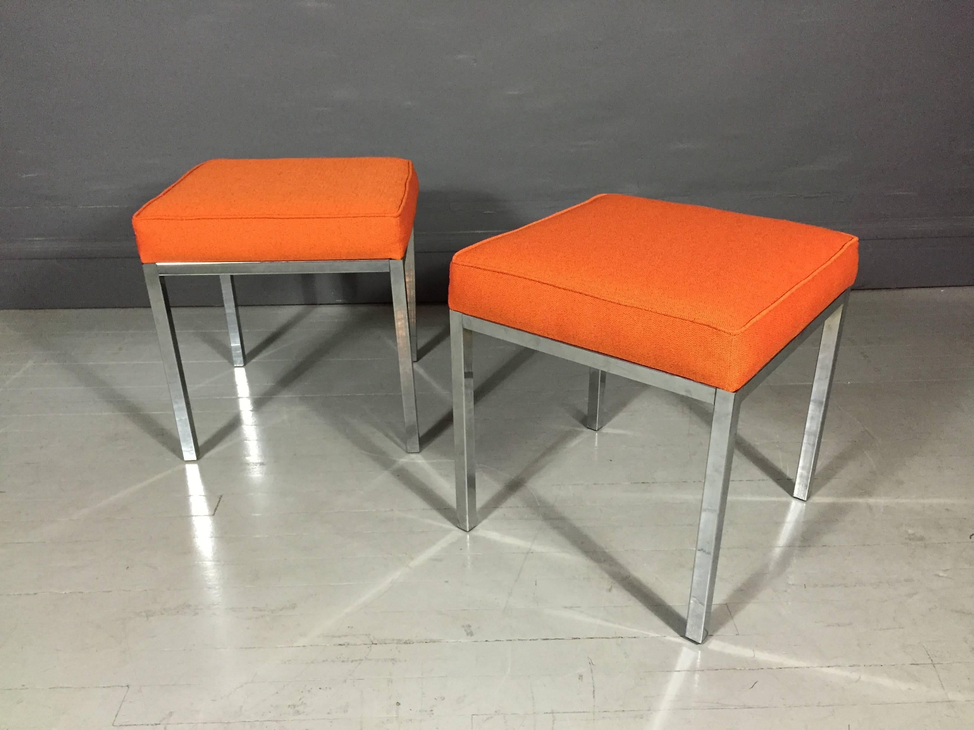 A Classic pair of square benches with chrome legs and newly upholstered in Kvadrat orange wool fabric. All original plastic cap feet, USA, circa 1970s.