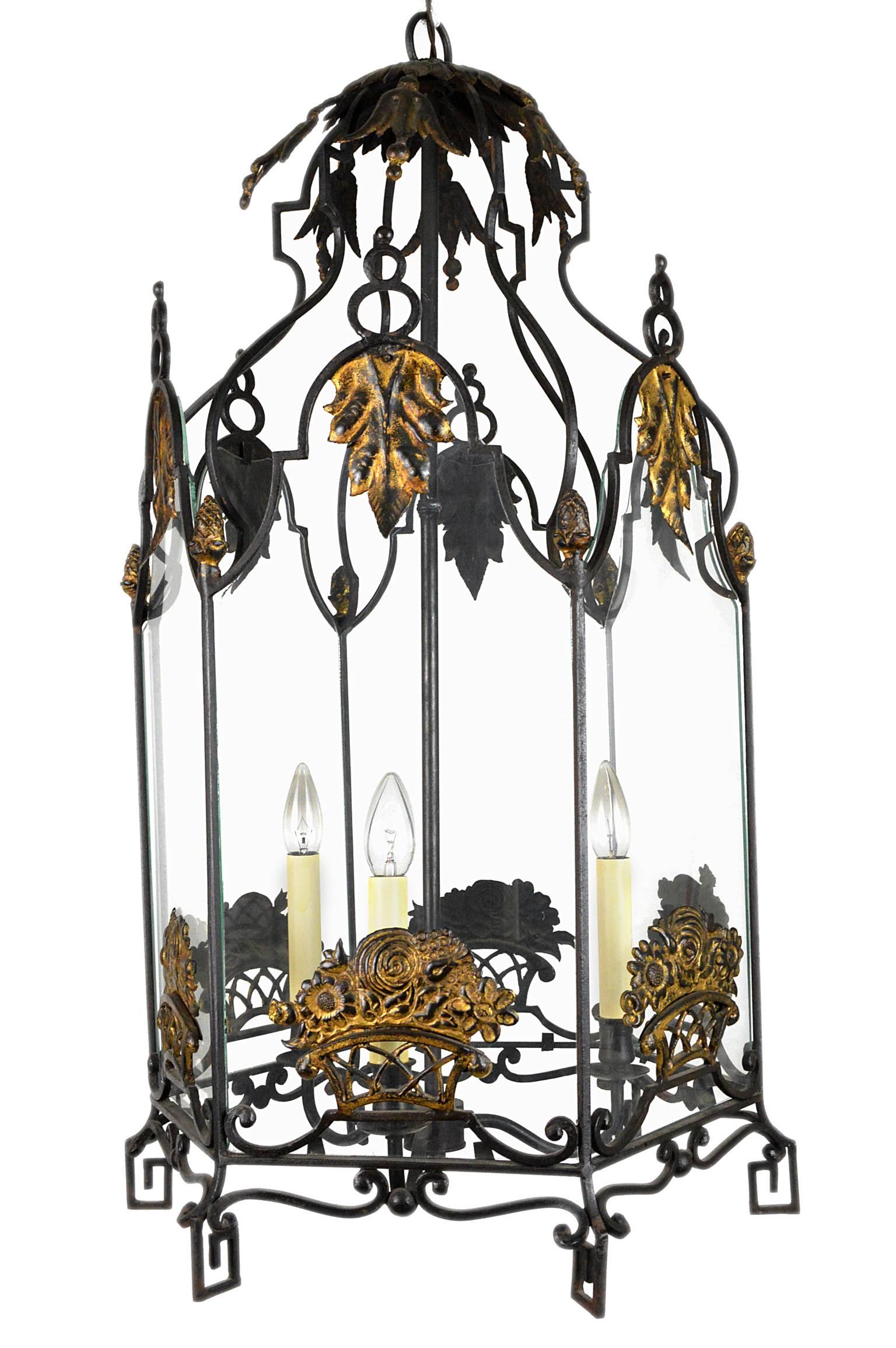 Fabulous wrought iron lantern of octagonal form with gilt flower basket applications.