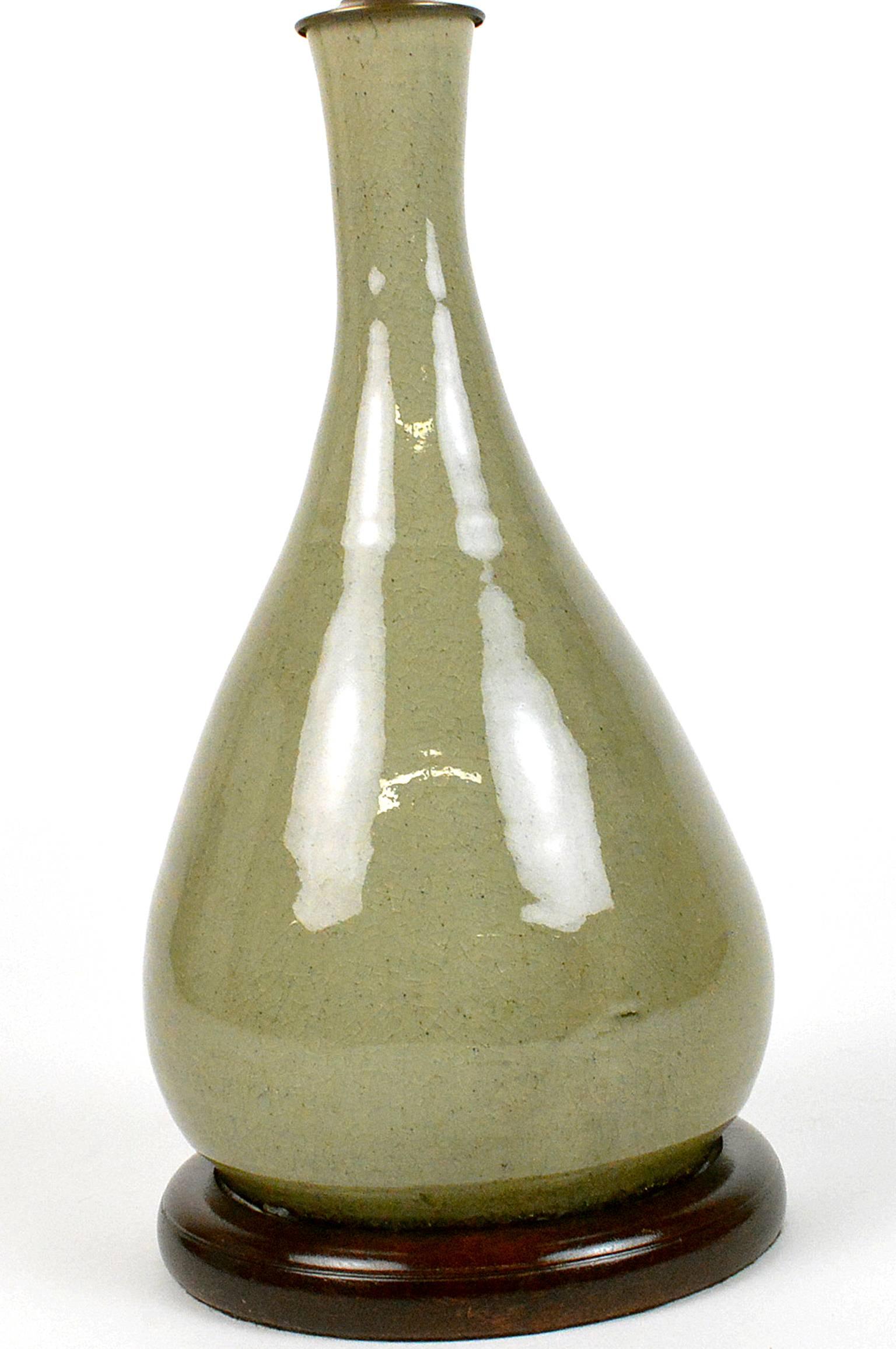 Asian celadon craquelure vase mounted as a lamp; crackle fern green glaze bottle shaped vase on custom wood base.

21.25