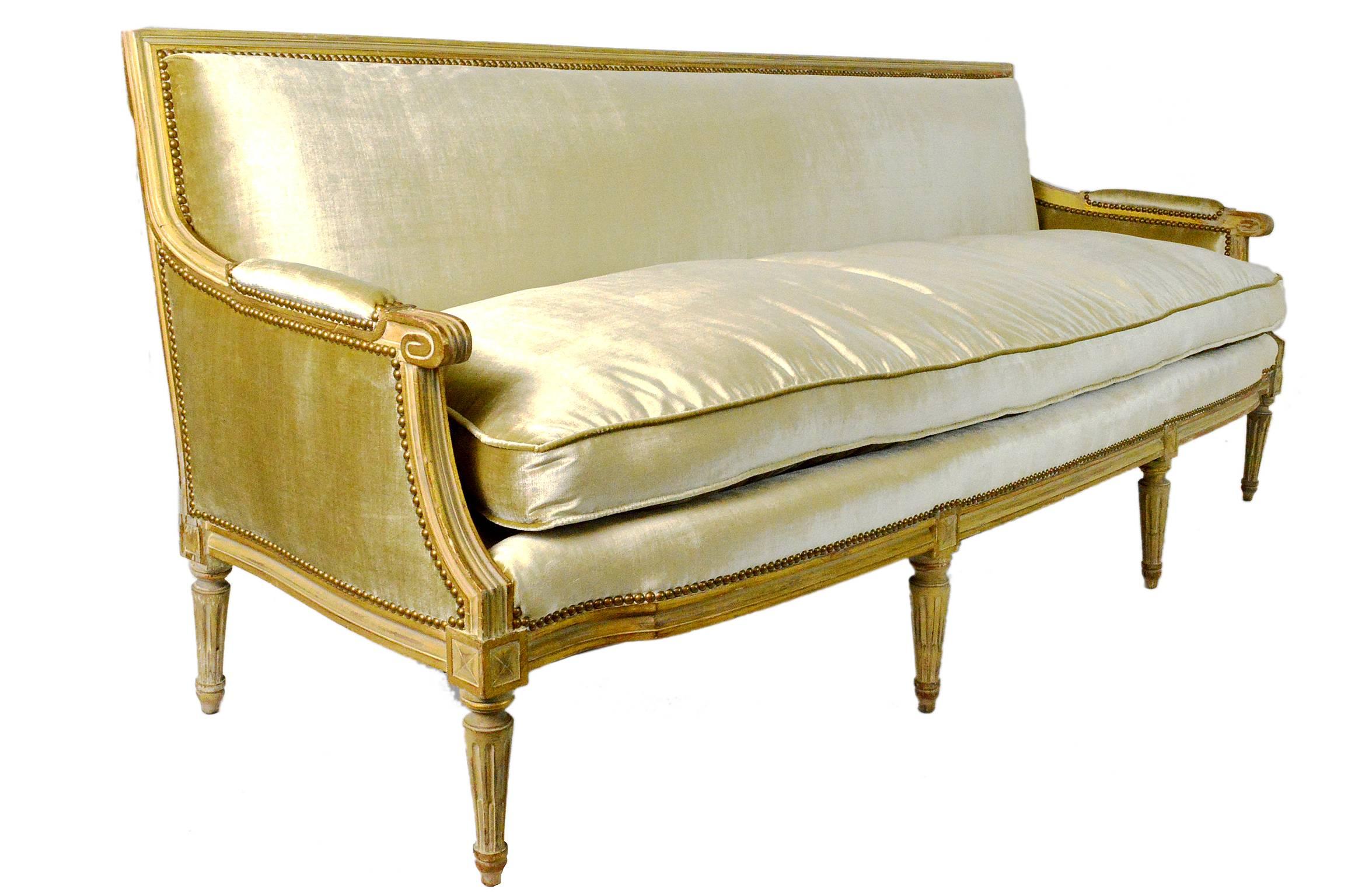 Elegant French Louis XVI style painted upholstered in a daffodil yellow silk velvet upholstery.