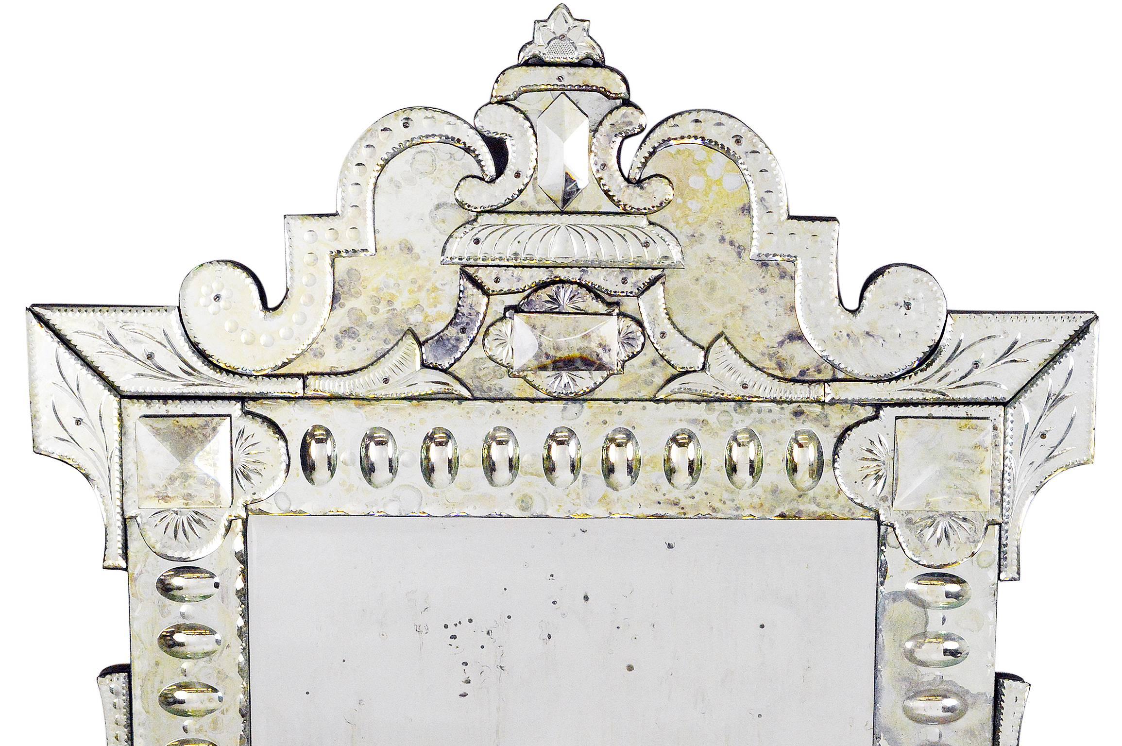 Monumental Venetian style mirror with crest top and delicate details, fabulous quality throughout.