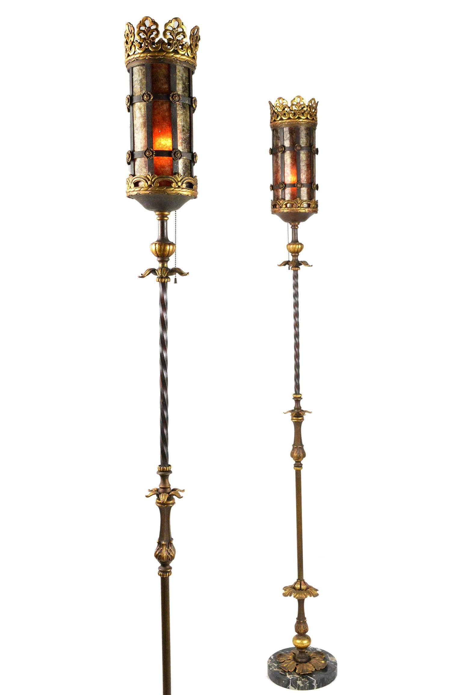 Pair of early 20th century Oscar Bach style floor lamps. Raised on marble bases, made of iron, with a polychrome painted gilt finish throughout. Having beautiful cylindrical mica shades.