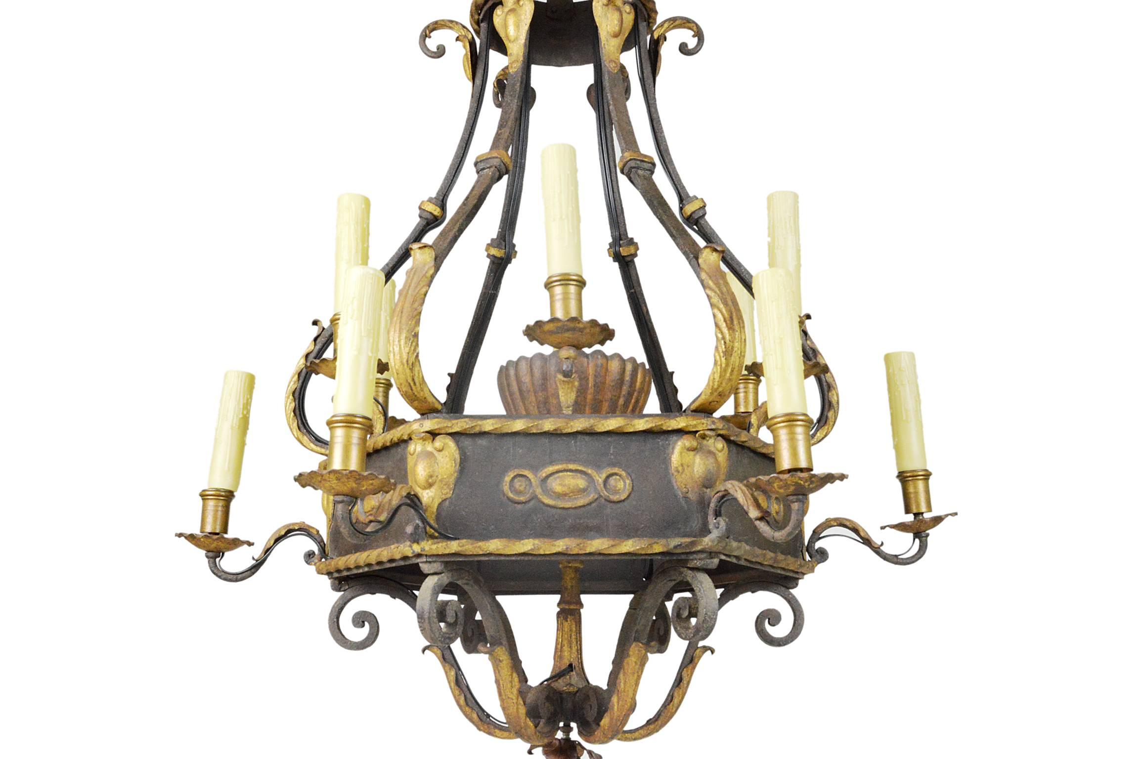 Monumental French iron parcel-gilt ten-light chandelier having crown form top. Excellent condition, recently re-wired, maintaining its original patina throughout.