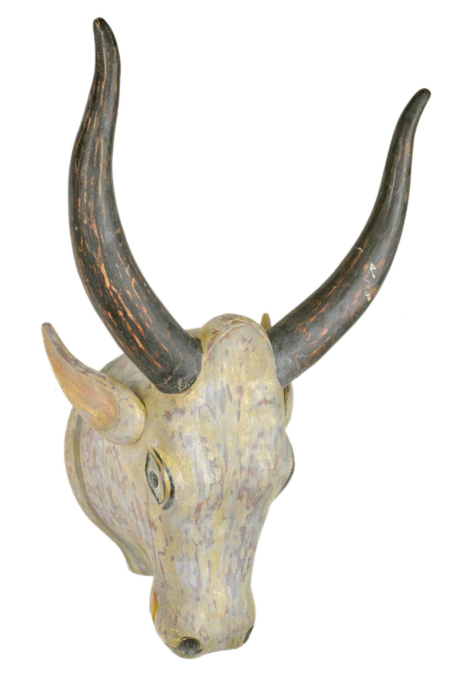 Polychrome mounted carved and painted Indian bull's head.