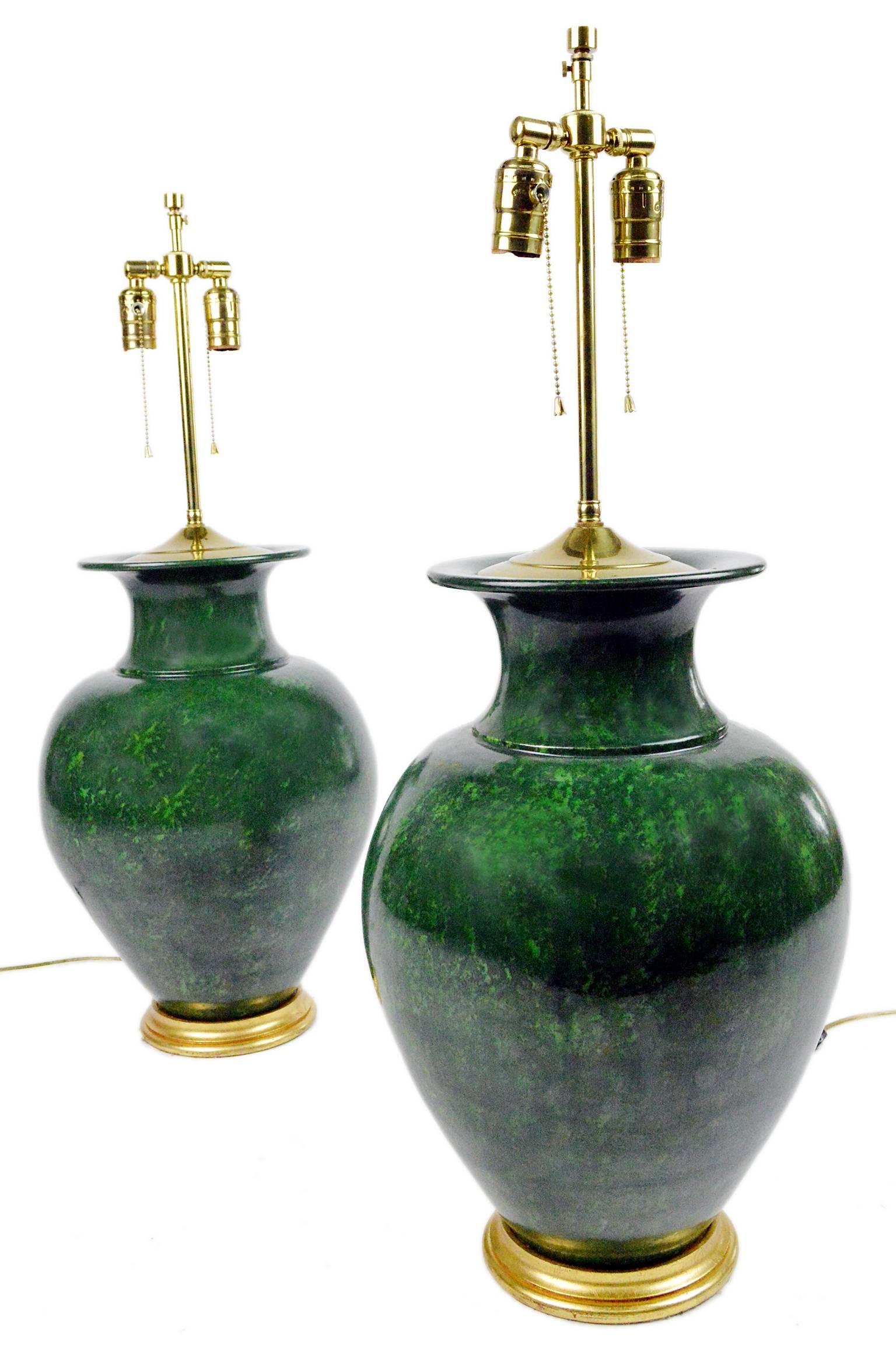 Pair large green urn form pottery table lamps of oversized form having green modeled finish set on gilt wood finish bases.

28