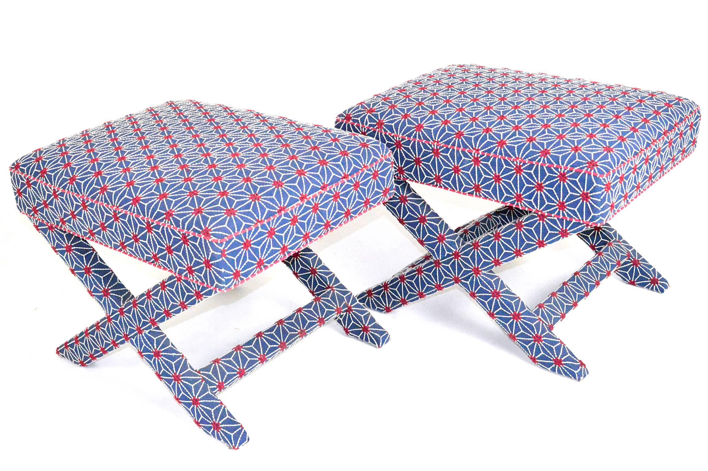 Pair of upholstered x-form stools in a red white and blue crewel upholstery.