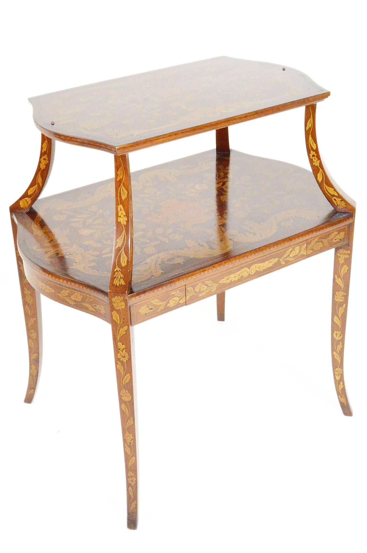 Dutch marquetry two-tiered tea table having a rectangular shaped top on scrolled supports over a conforming lower shelf above a single drawer with two brushing sides on cabriole legs, circa 1910.
    