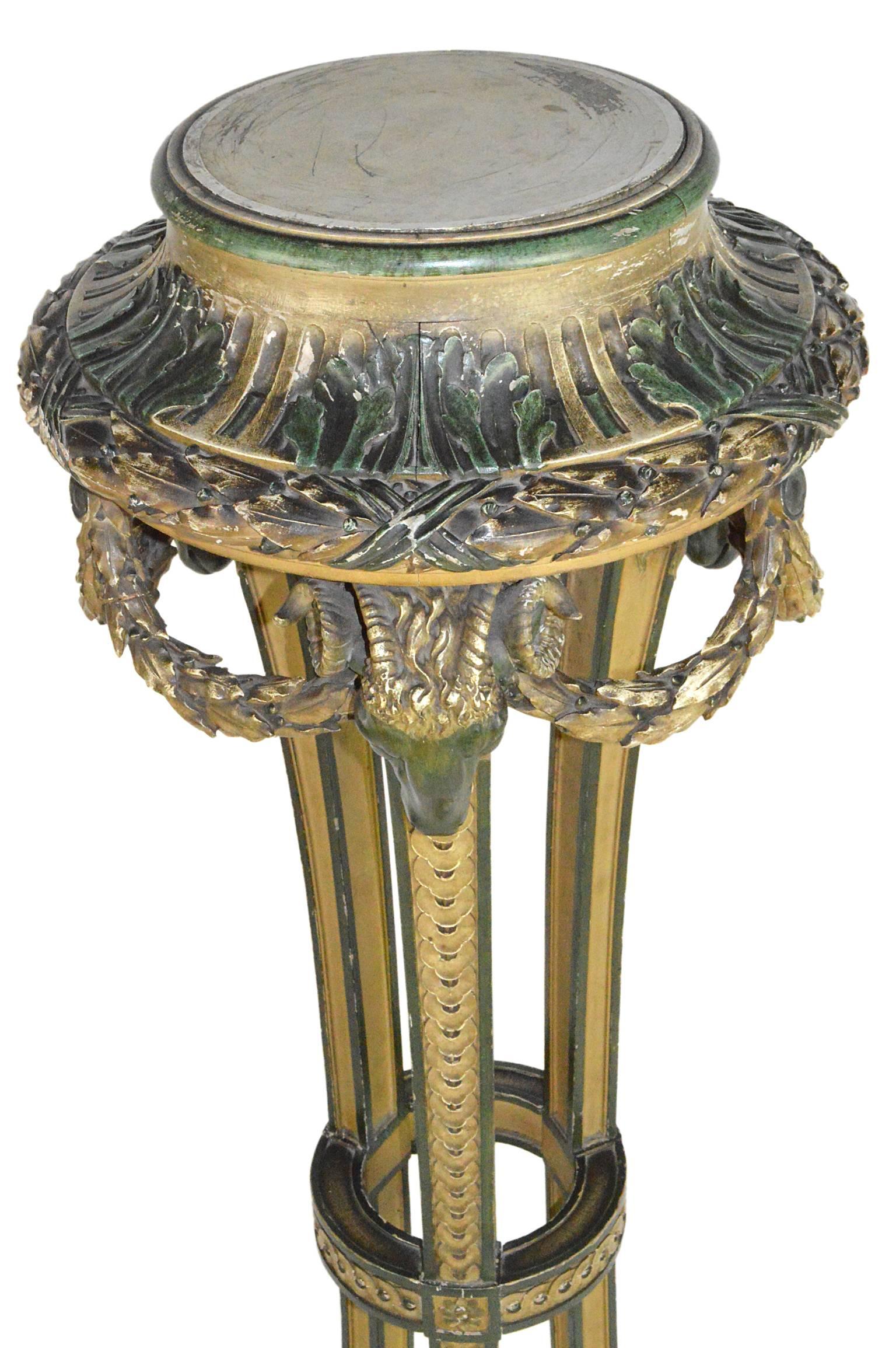 Louis XV style French painted pedestal having rams heads, ornate foliate designs ending in hoofed feet on tripartite base.
       
