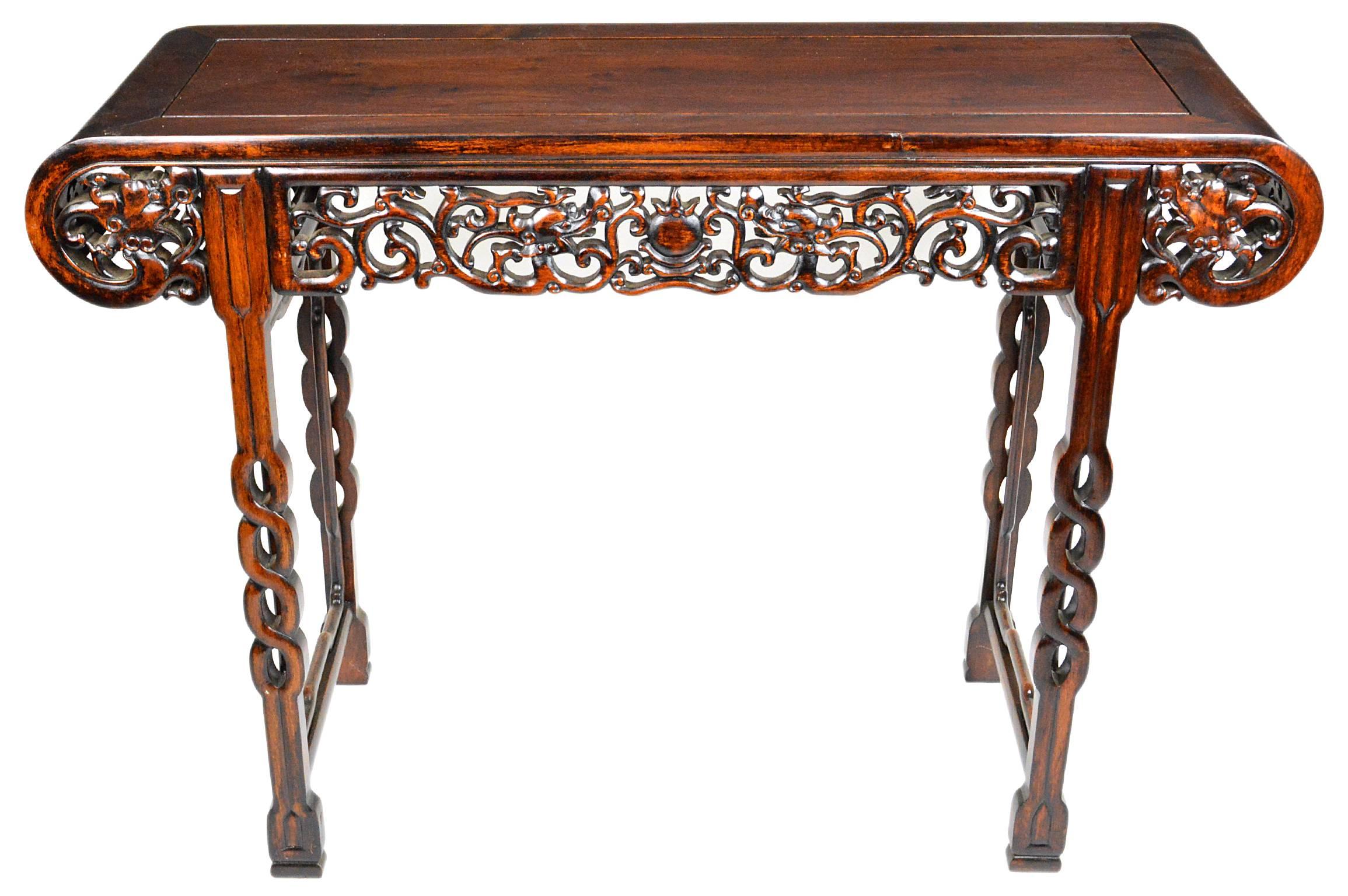Rosewood Chinese hand-carved altar table or console table having intricate Folk Art carving works on all sides and open carved infinity legs.