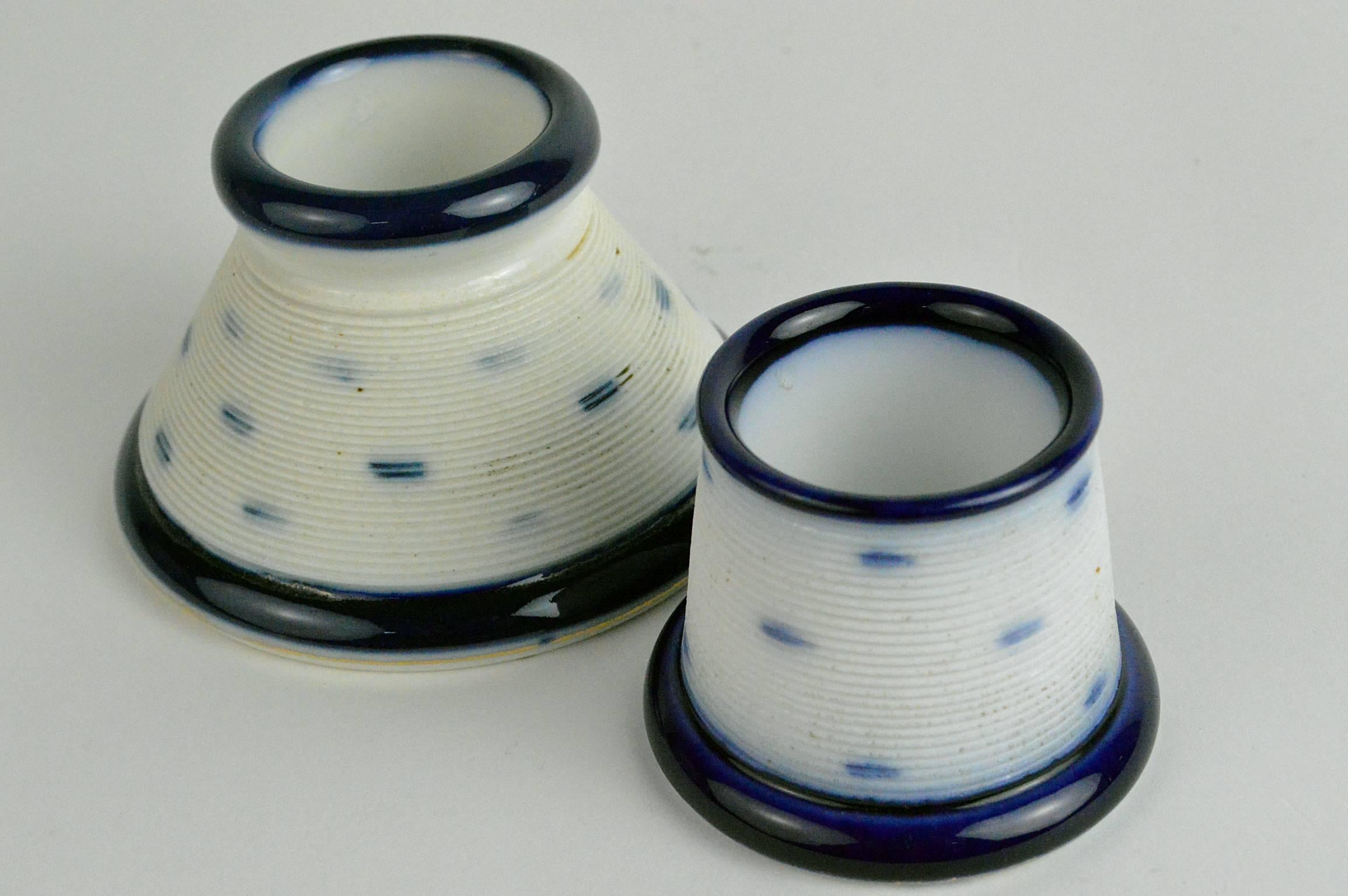Porcelain match strikers holders cobalt blue and white with rigid sides.
Smallest measures 2.25