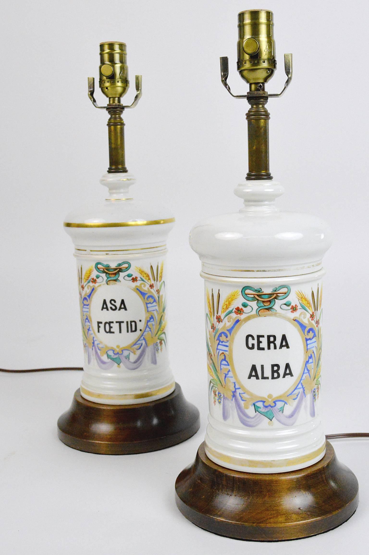 Pair French hand painted apothecary jars mounted as lamps. Each decorated in the Napoleonic style. 
Tallest measures 18